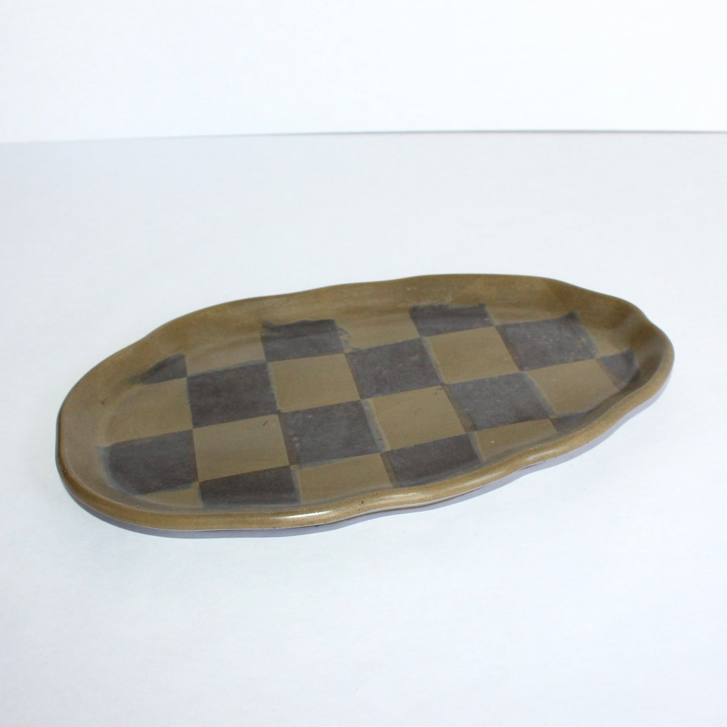 Checkered ceramic tray on a white background