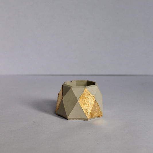 Geometric small jewelry dish with gold accent on a white background