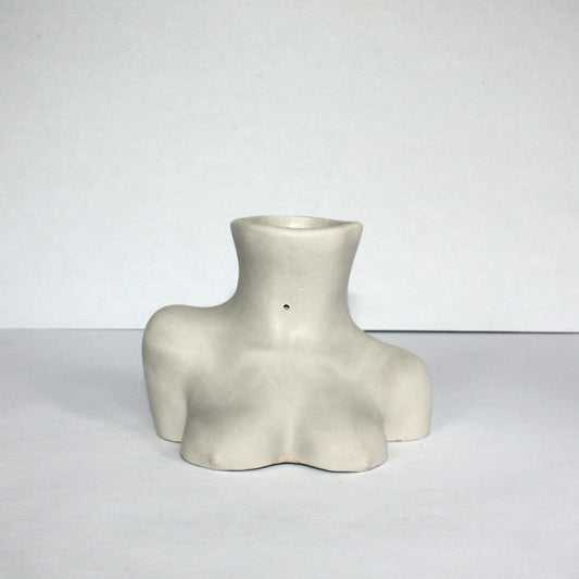 Light gray concrete female figure vase on a white background