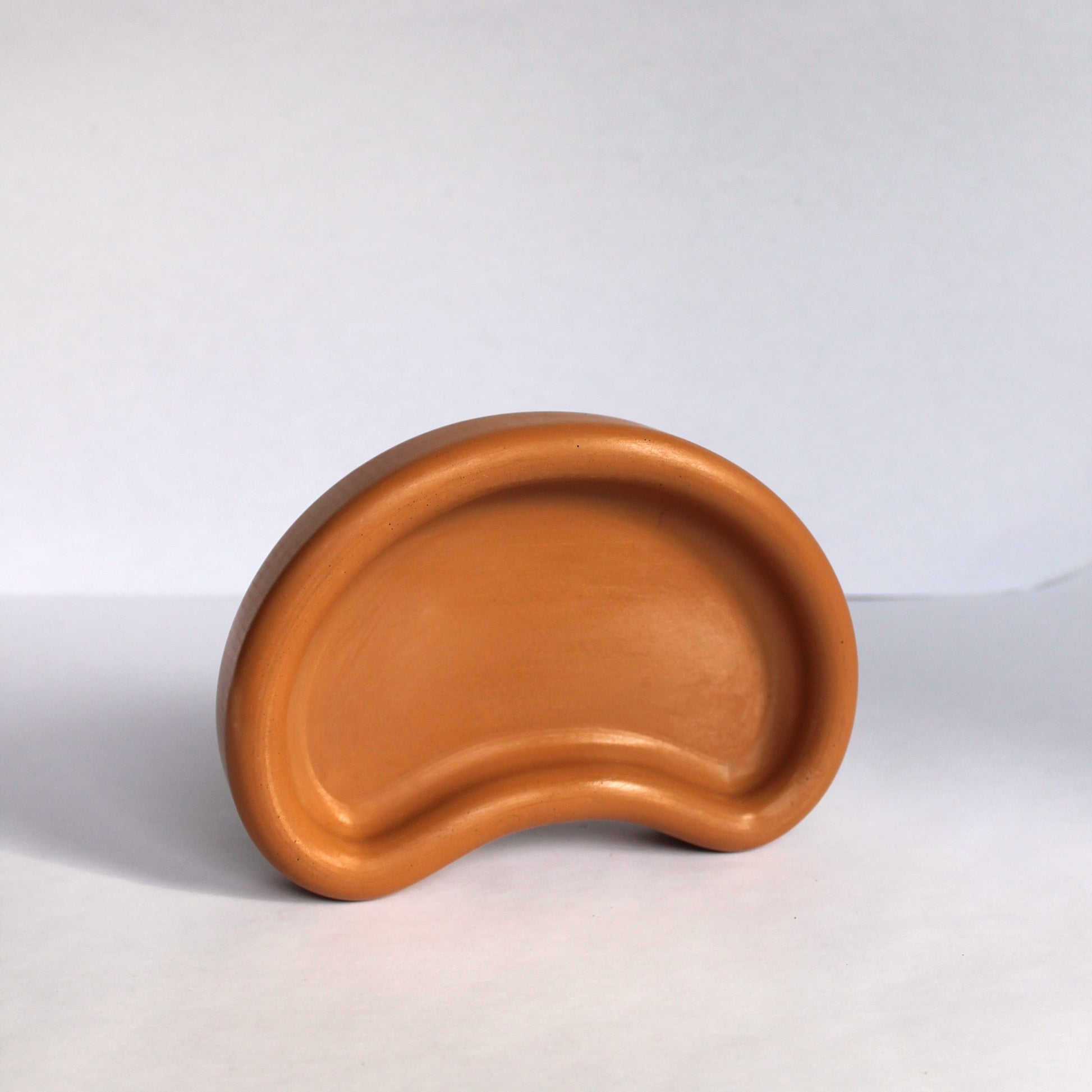 Thick concrete tray standing up on its side on a white background