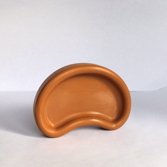 Thick concrete tray standing up on its side on a white background