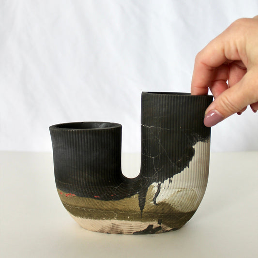 Black, green and gray concrete vase with a unique design on a white background