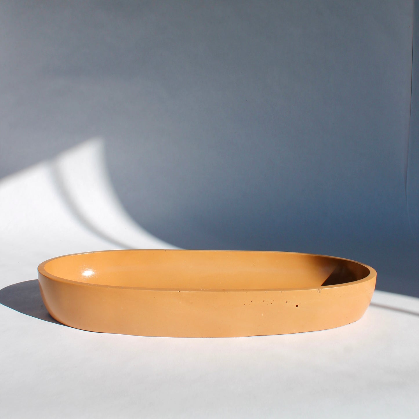 side view of concrete oval bowl in terracotta color