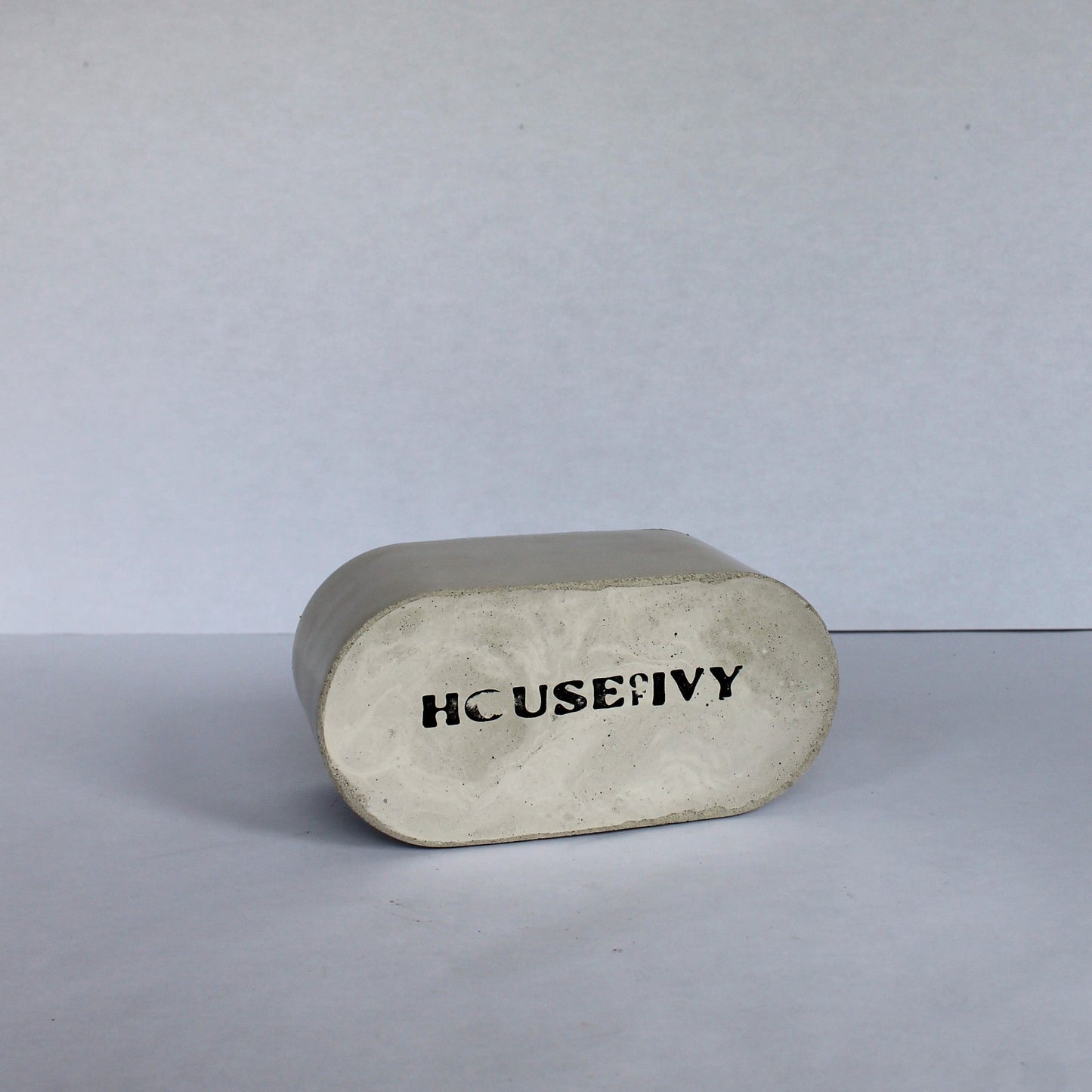 Bottom of rectangular stone colored dish with 'HOUSE OF IVY' branding on a white background