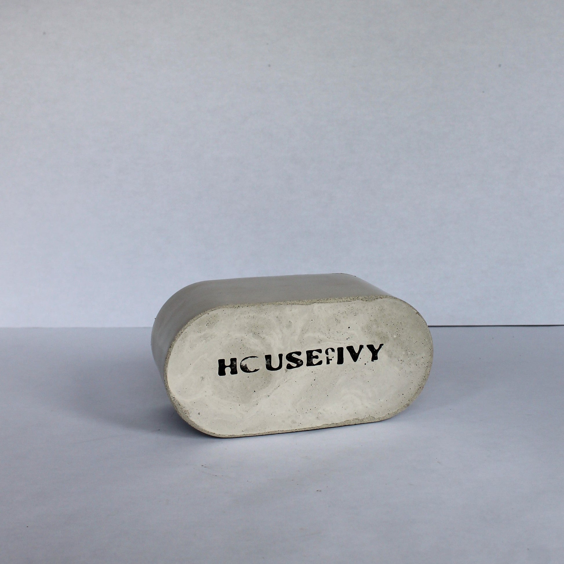 Bottom of rectangular stone colored dish with 'HOUSE OF IVY' branding on a white background
