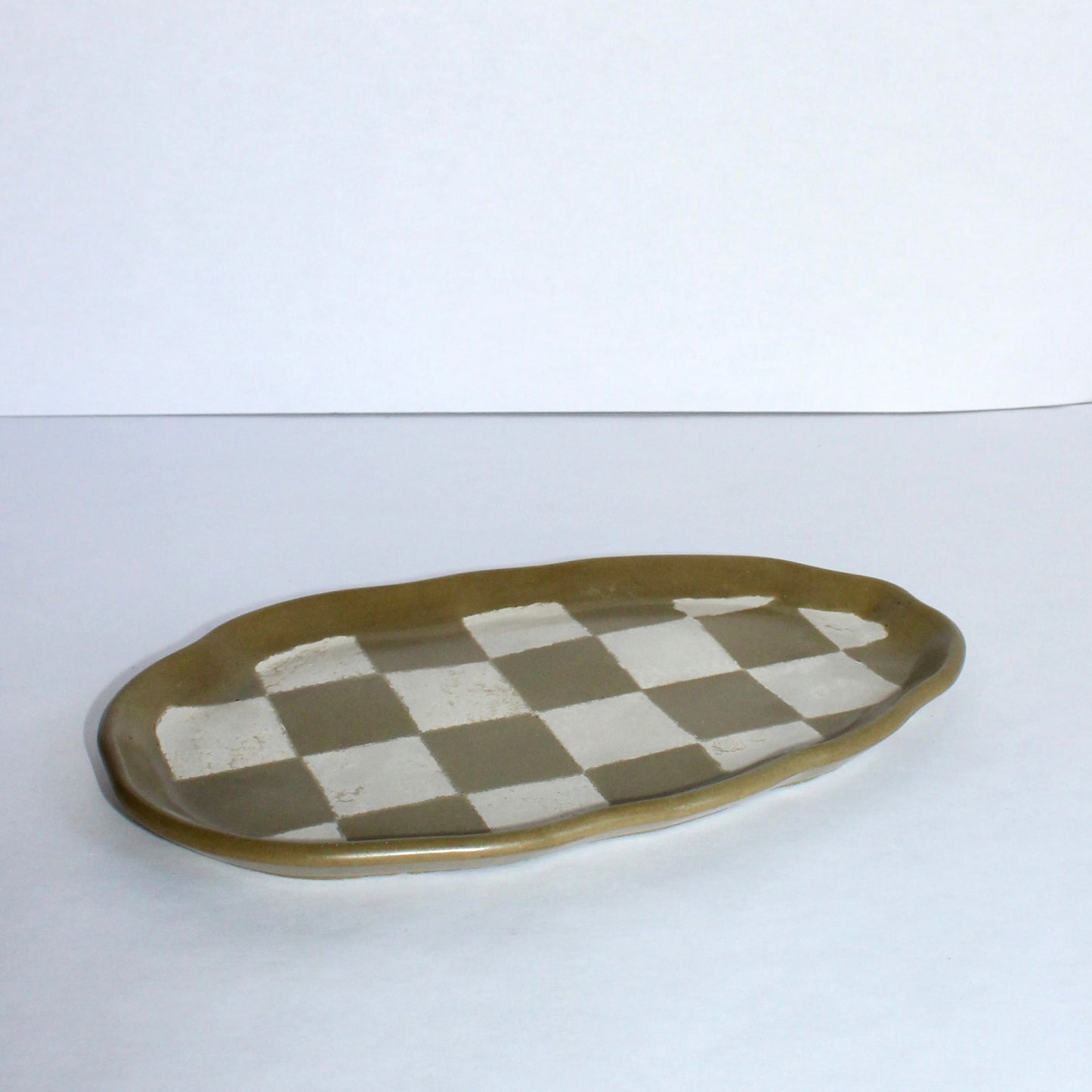 Checkered concrete plate on a white surface