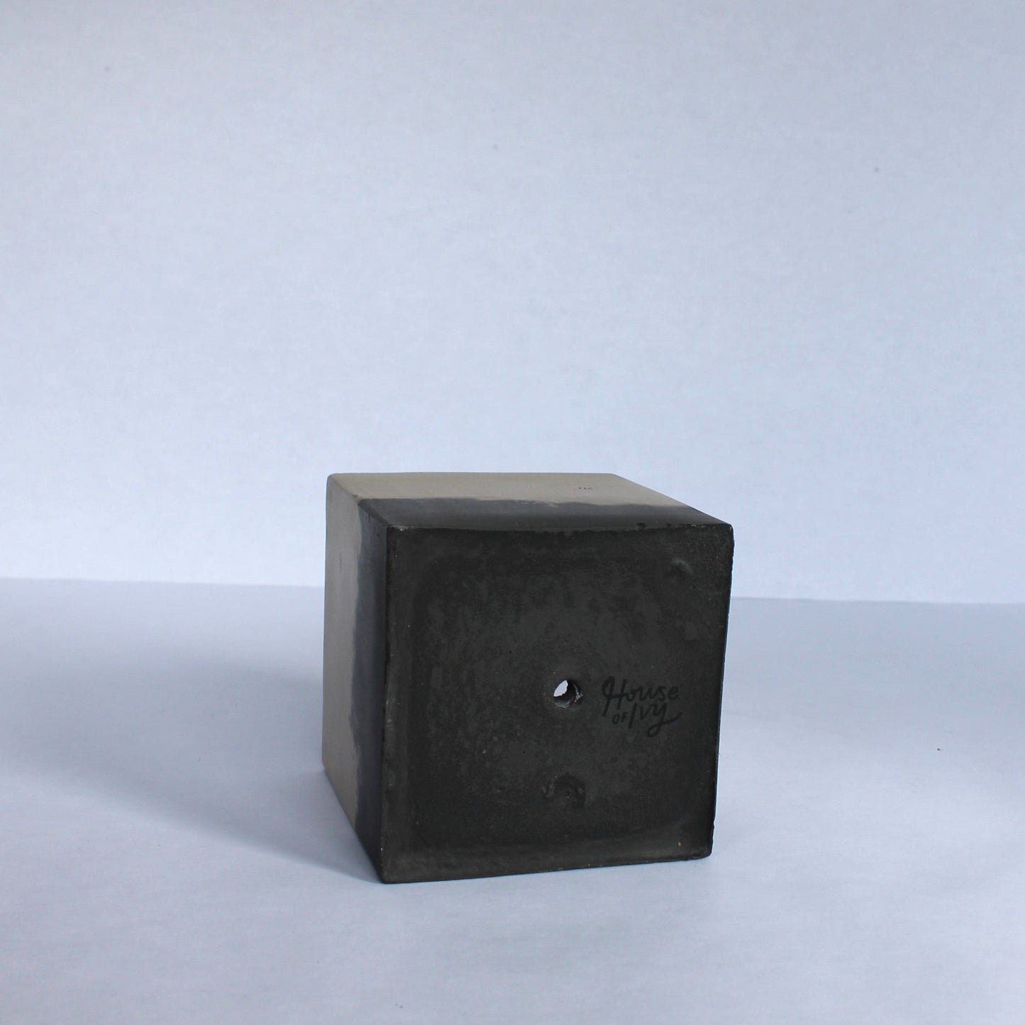 Bottom of black planter on a white background