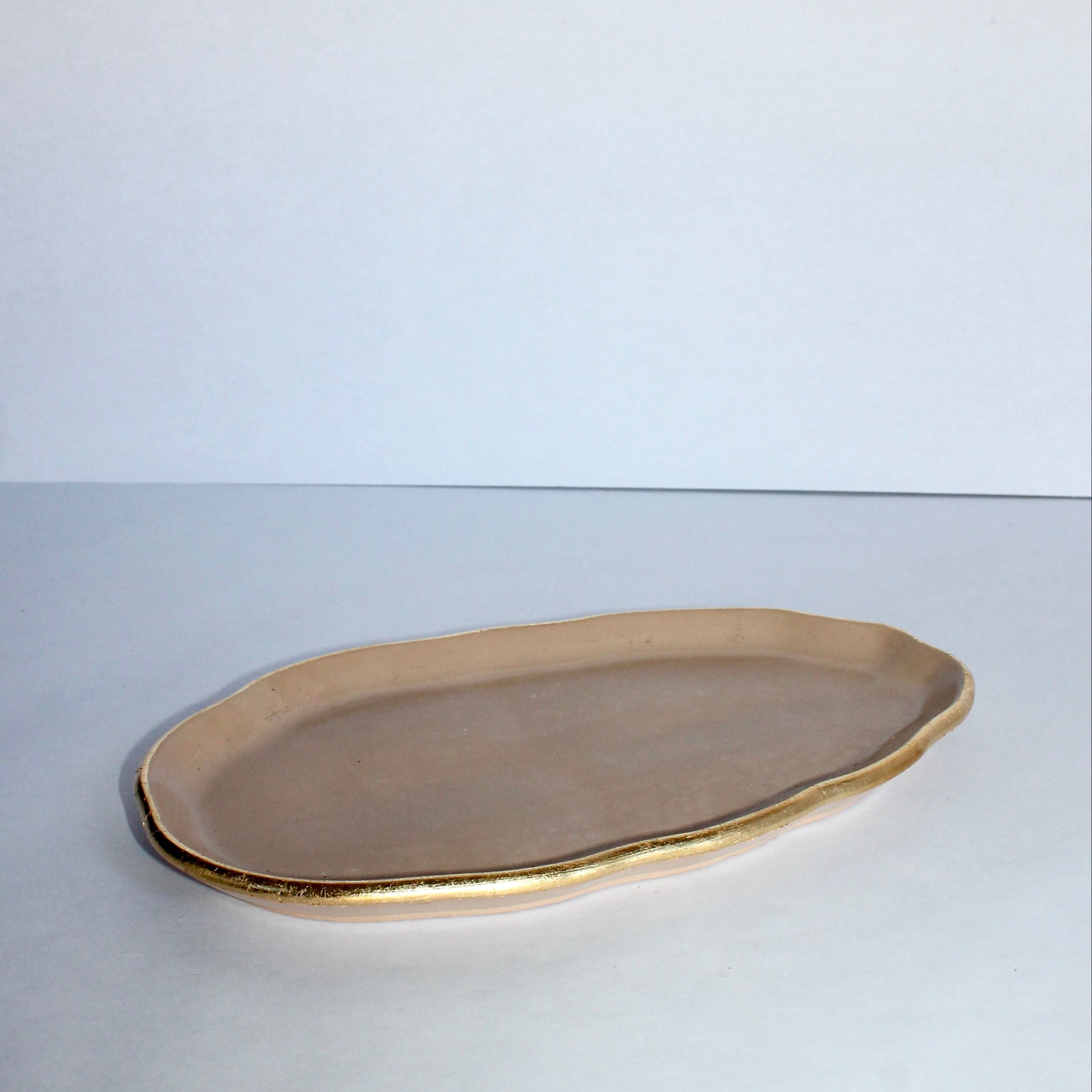 Beige concrete tray on a white surface with a white background