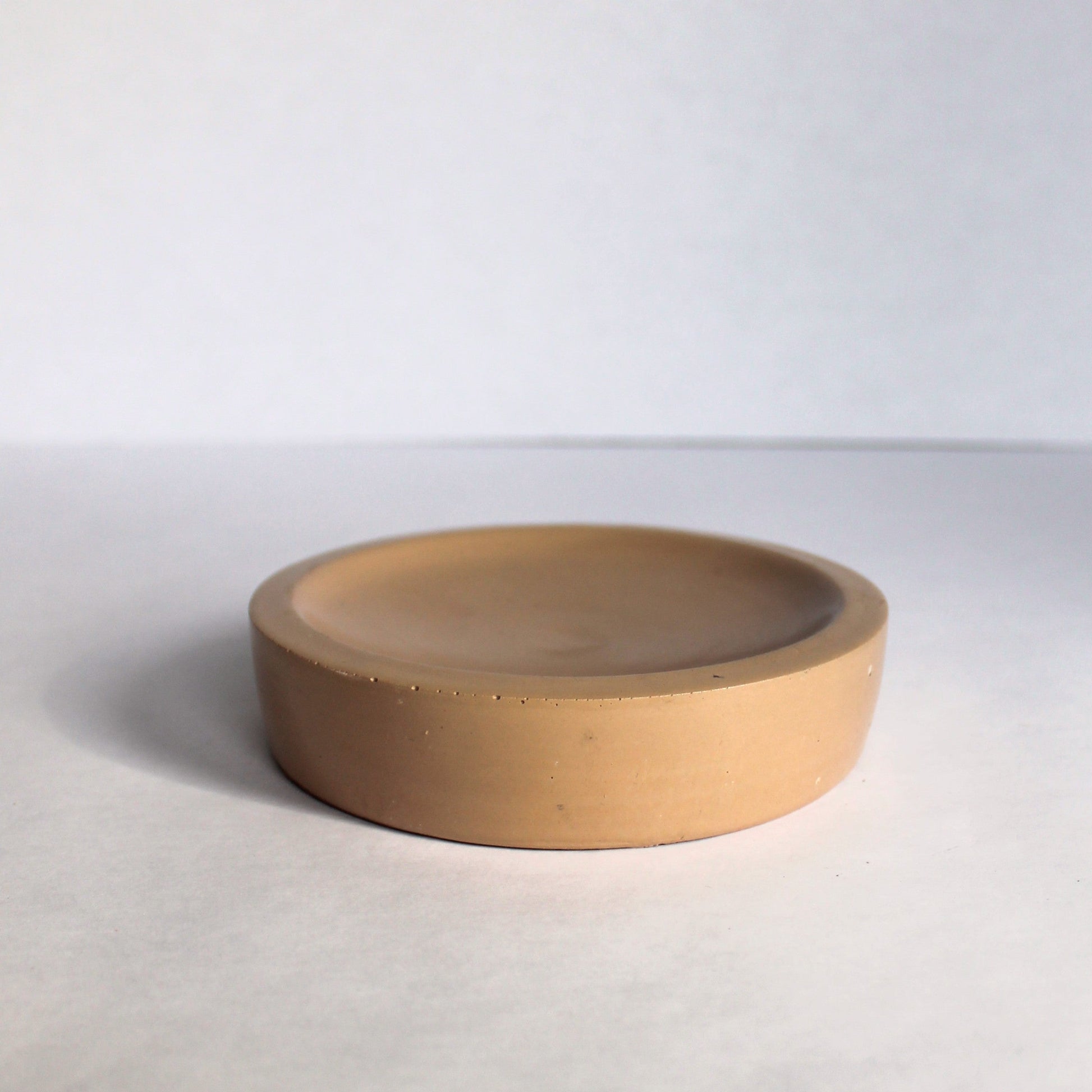 Beige concrete bowl on a white background