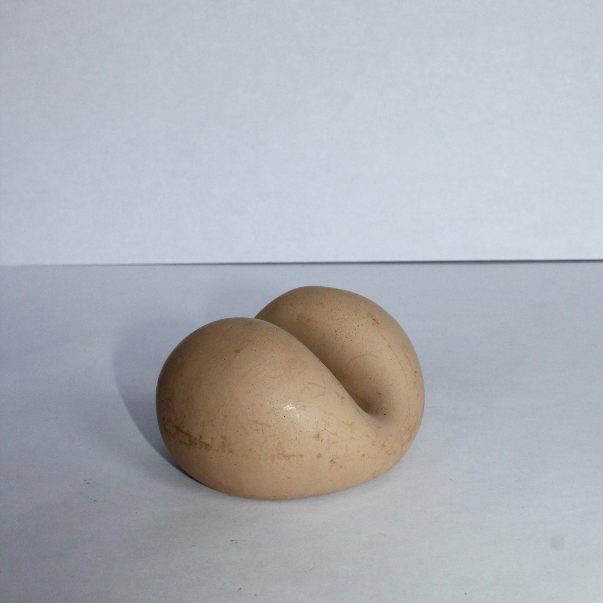 Beige concrete phone stand on a white background