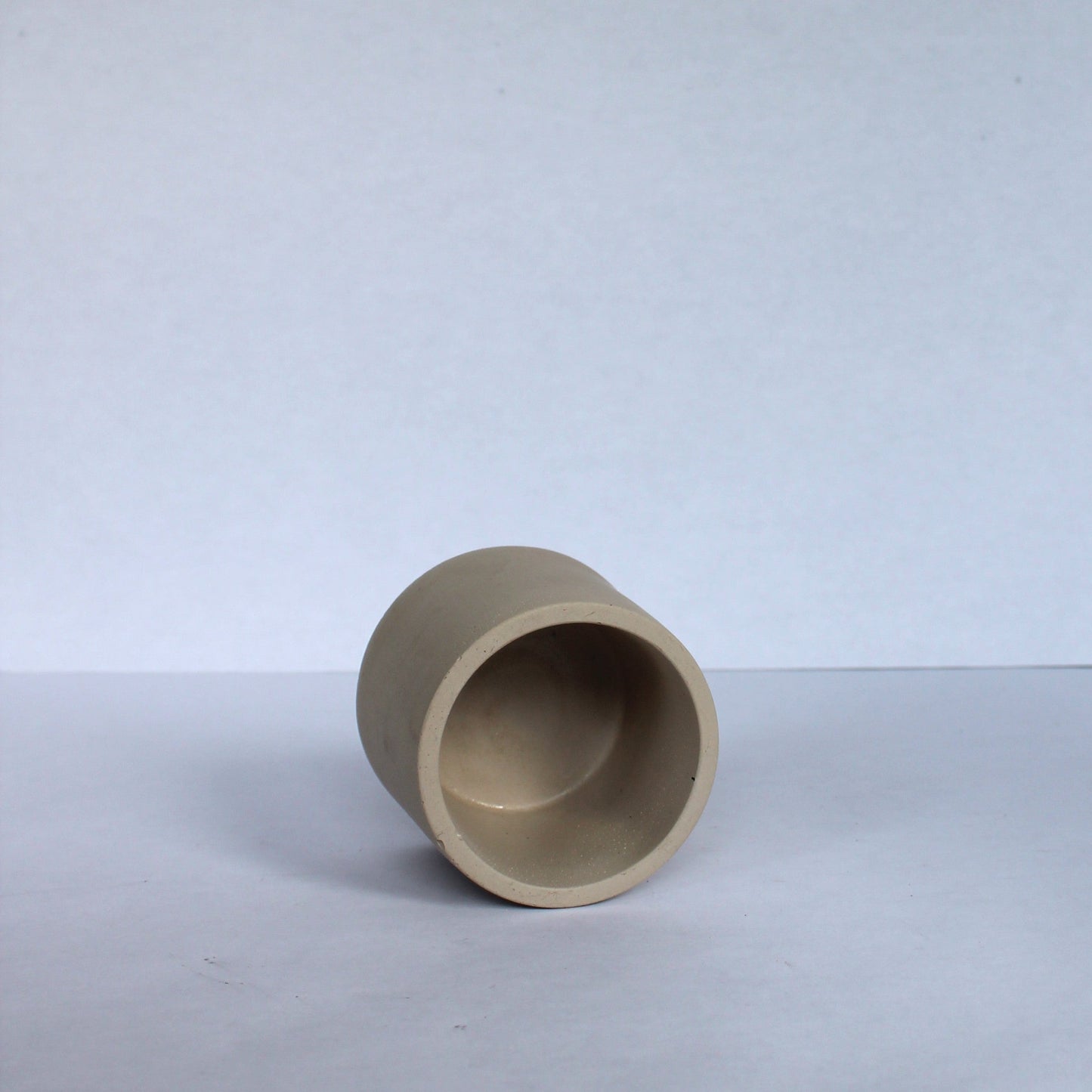 Beige concrete pot on a white background