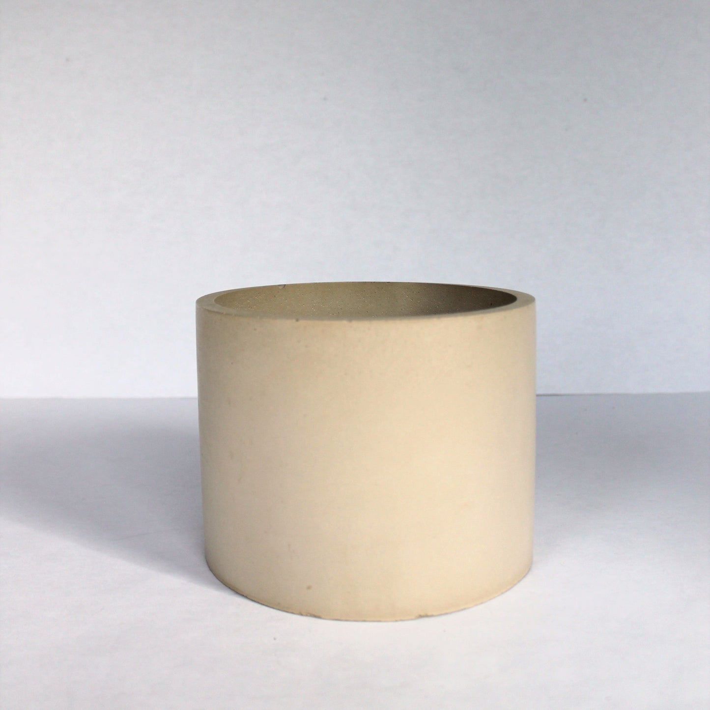 Beige concrete planter on a white background