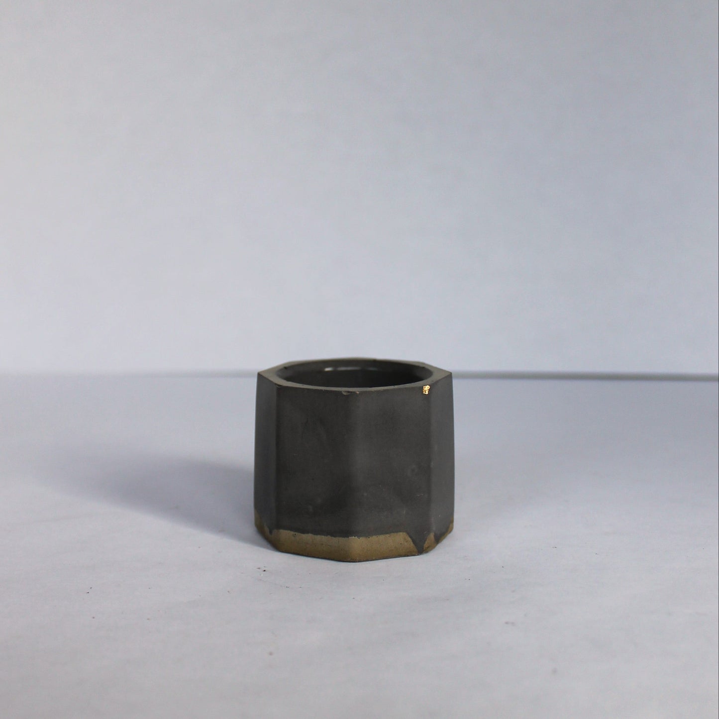 Black concrete planter on a white background