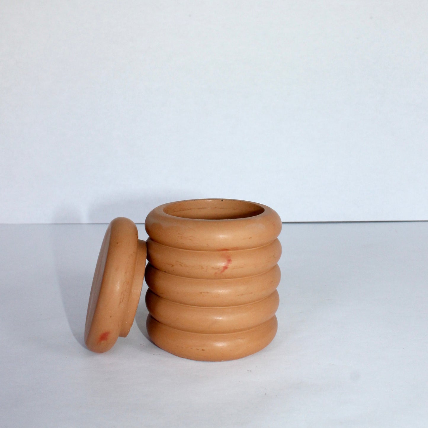 clay container with a lid on a white background