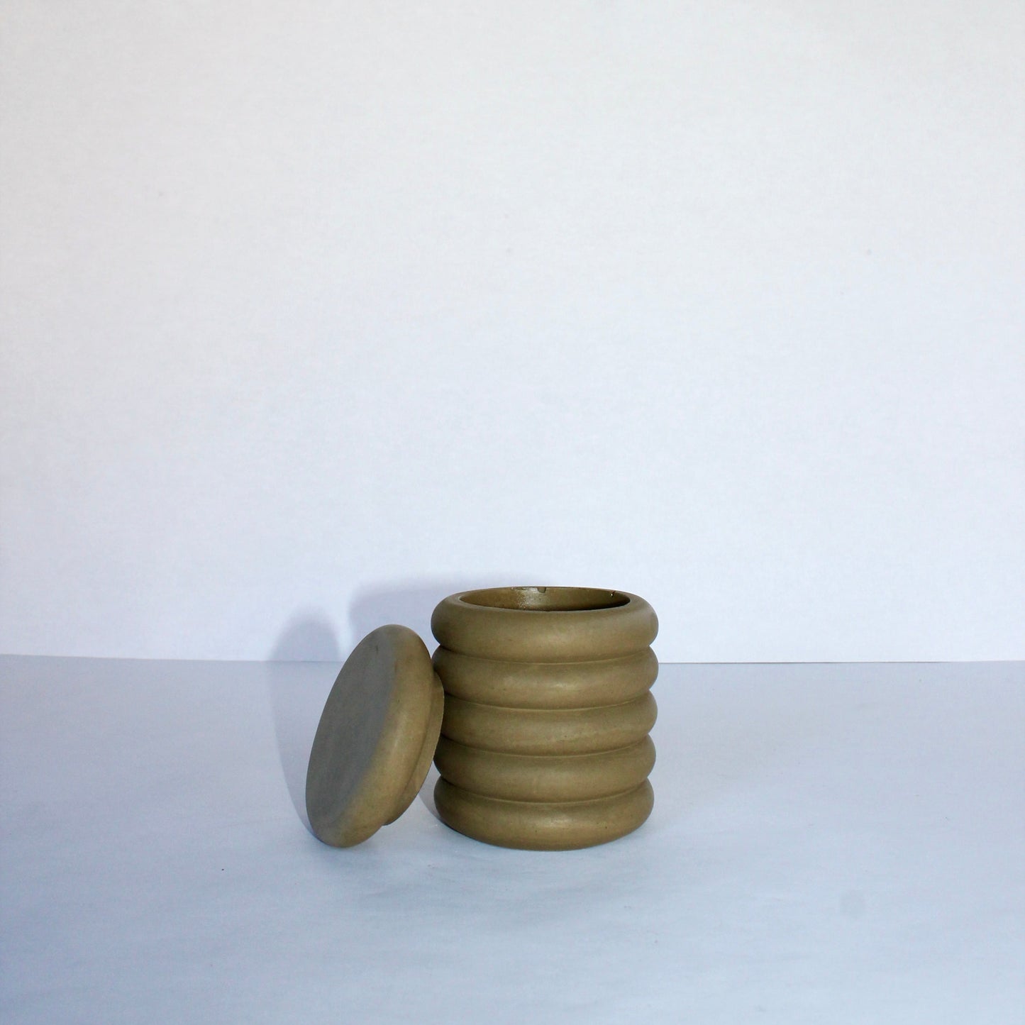 Concrete jar with lid on a white background