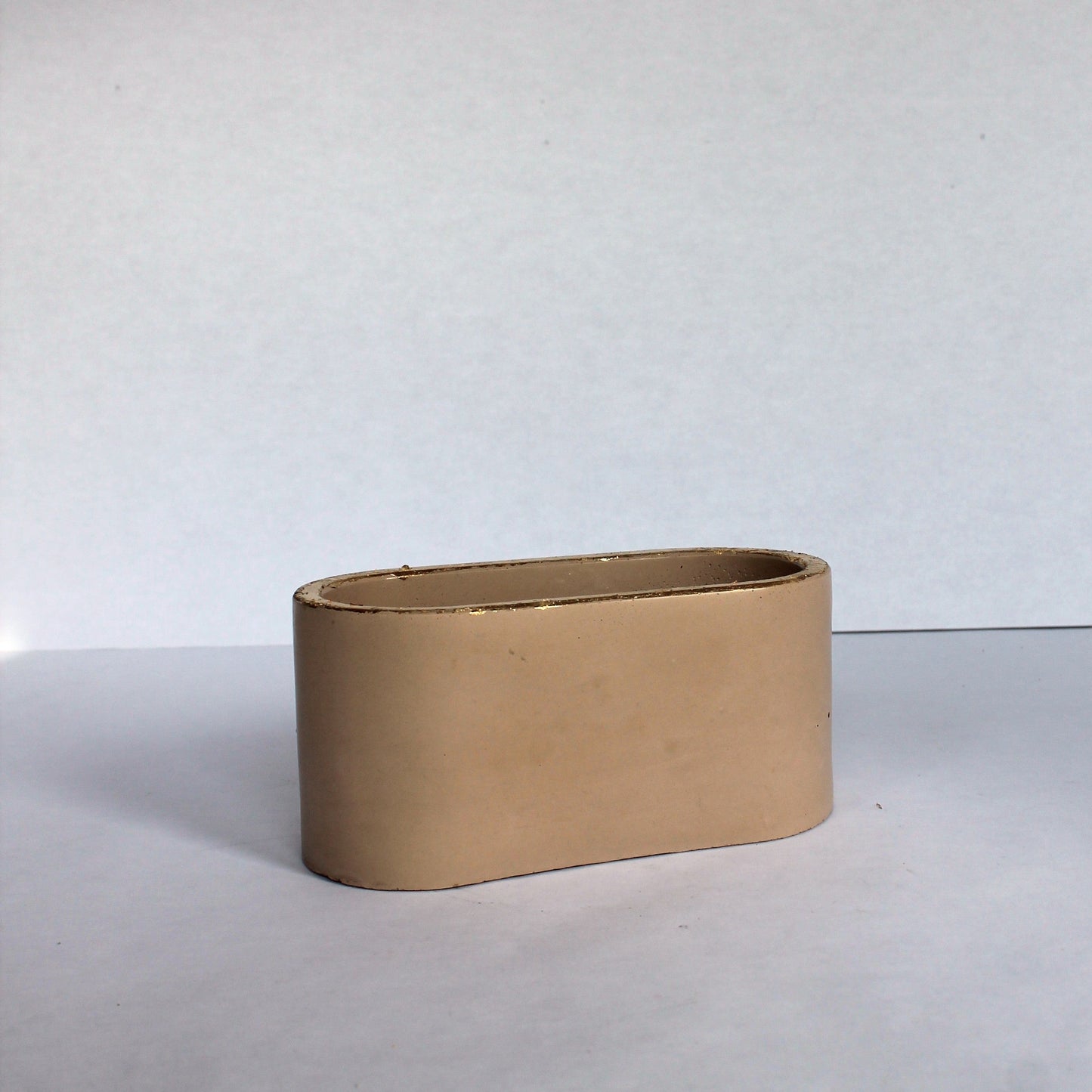Beige colored rectangular object on a white background
