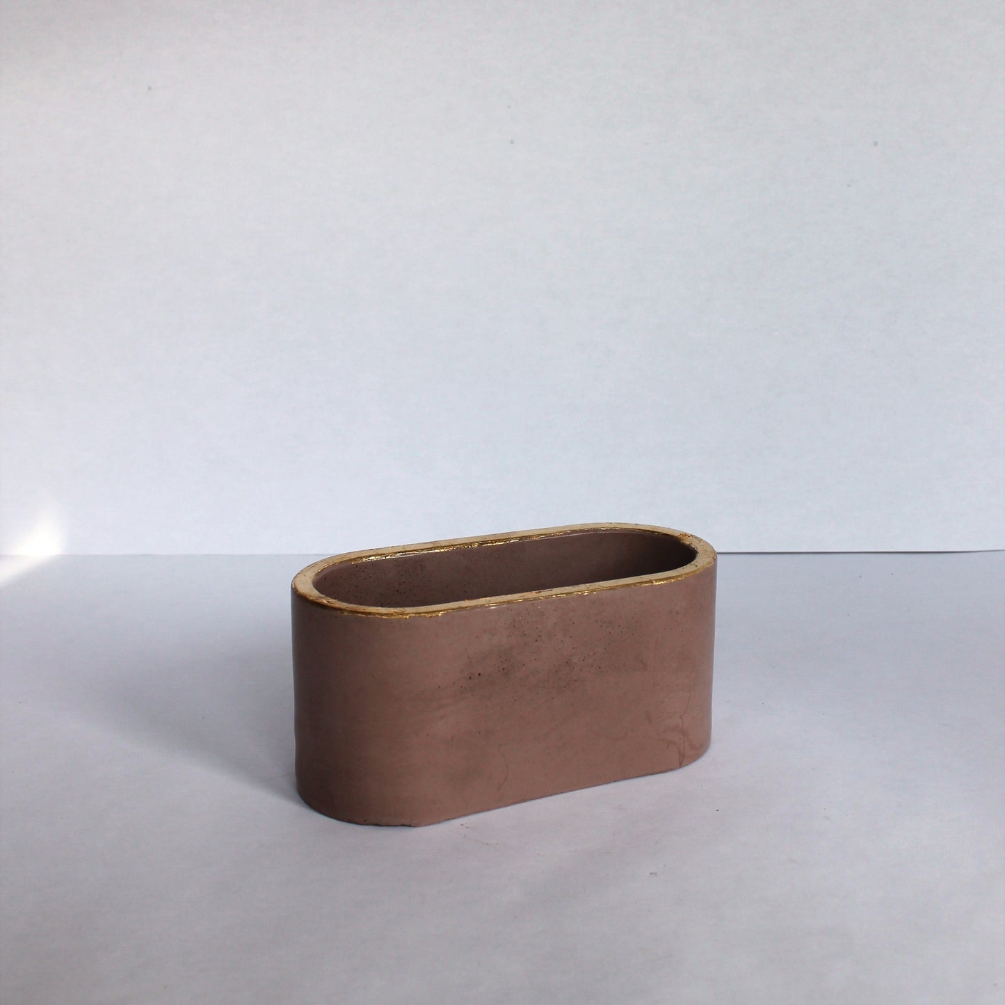 Brown concrete dish on a white background
