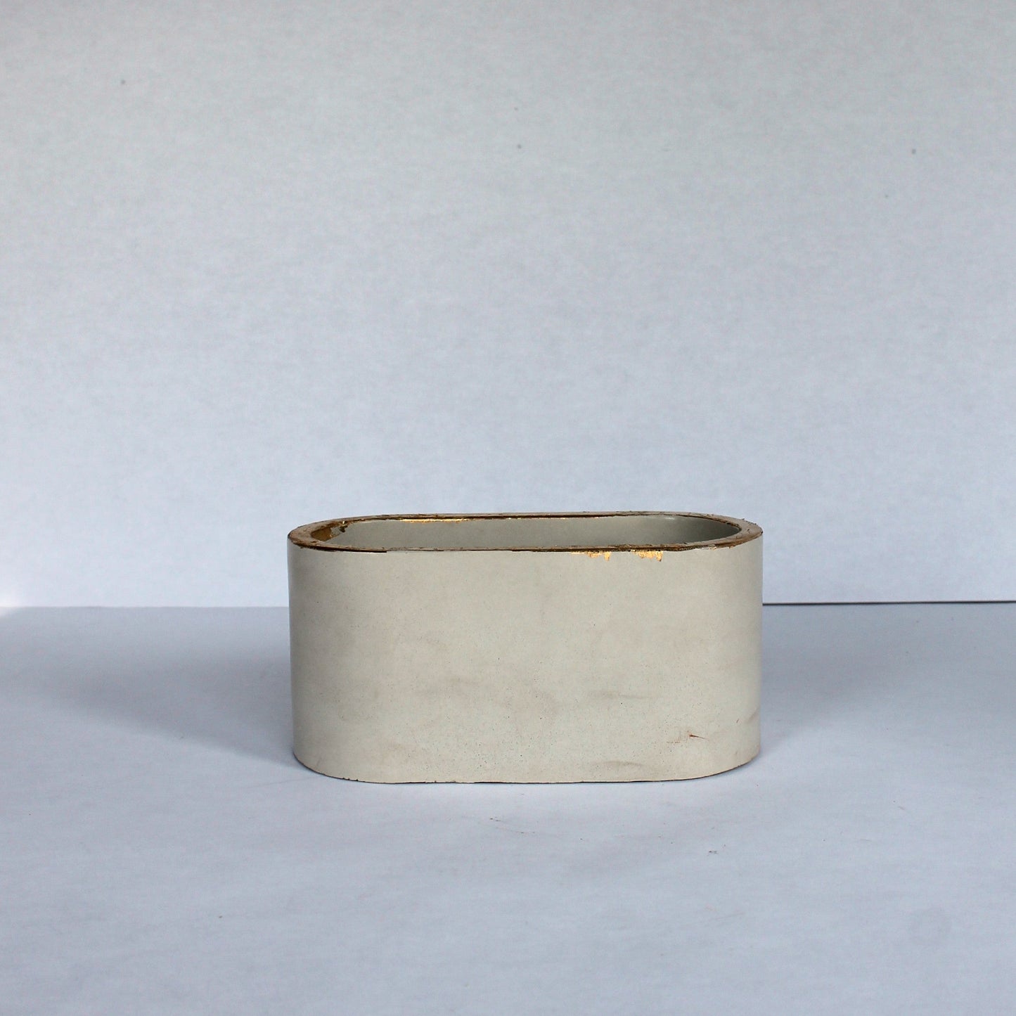 Oval concrete planter on a white background