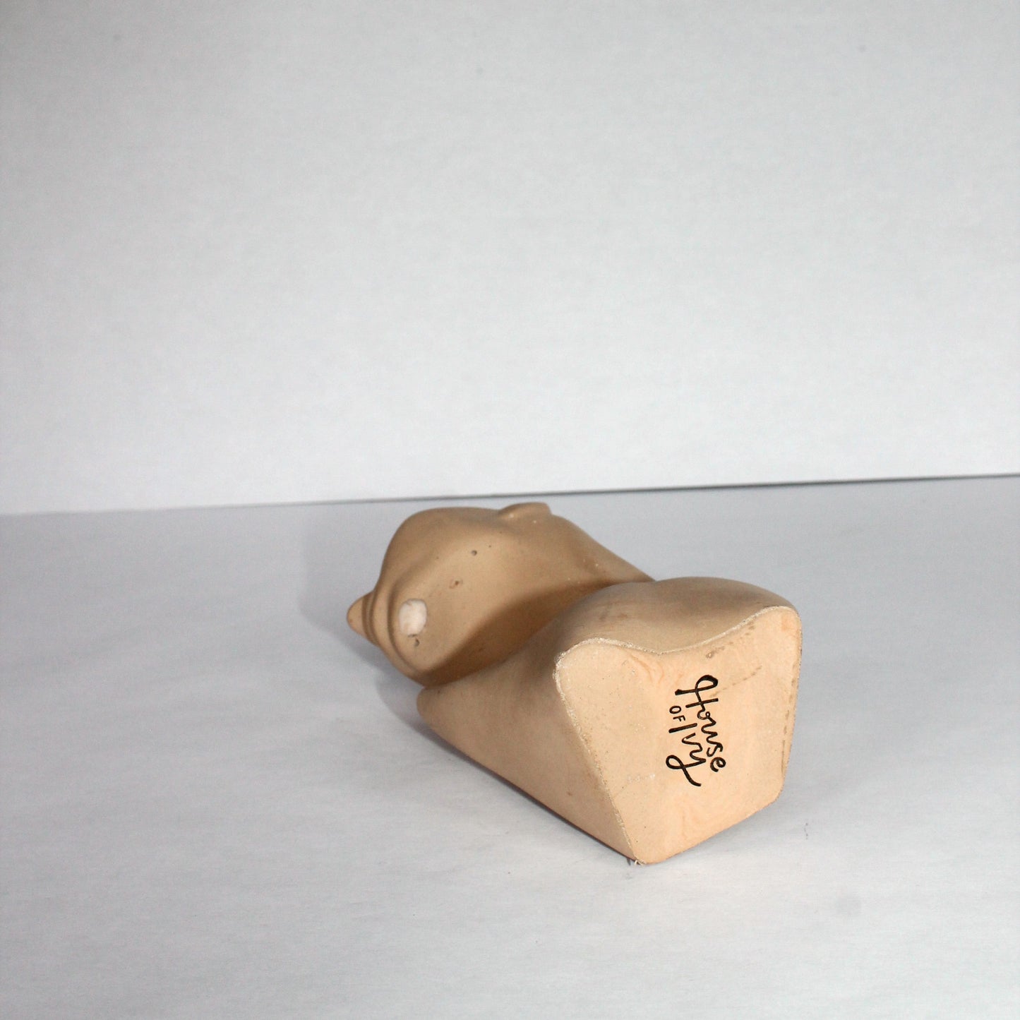 concrete sculpture with a carved face on a white surface