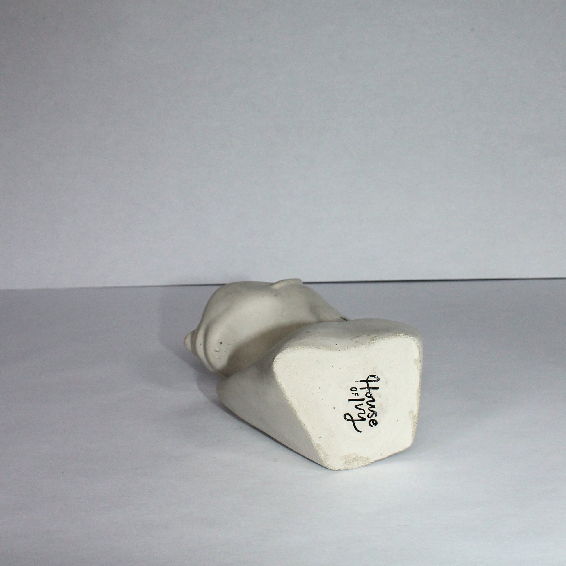 White ceramic object with 'House of Ivy' branding on a white background