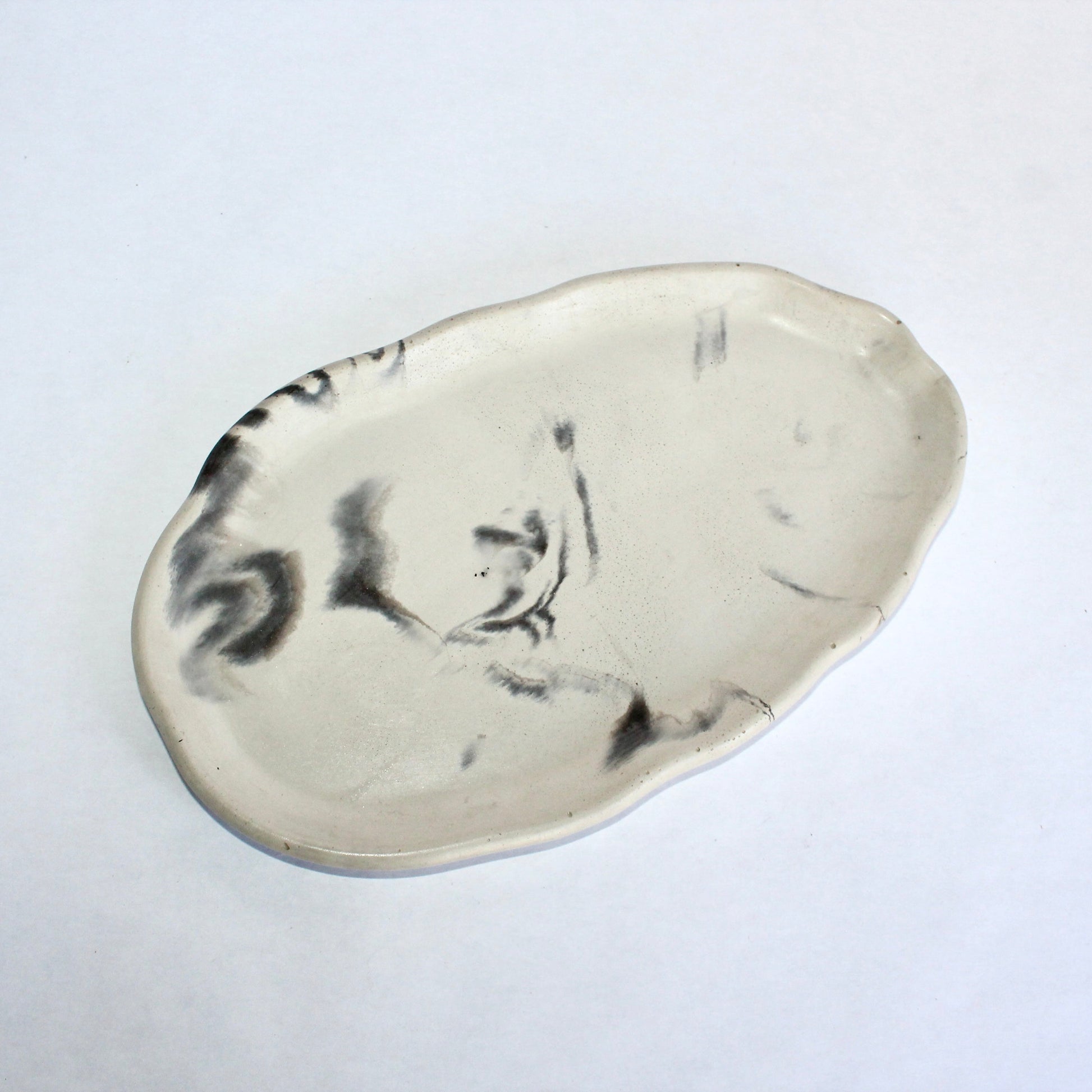 White concrete tray with black marble design on a white background