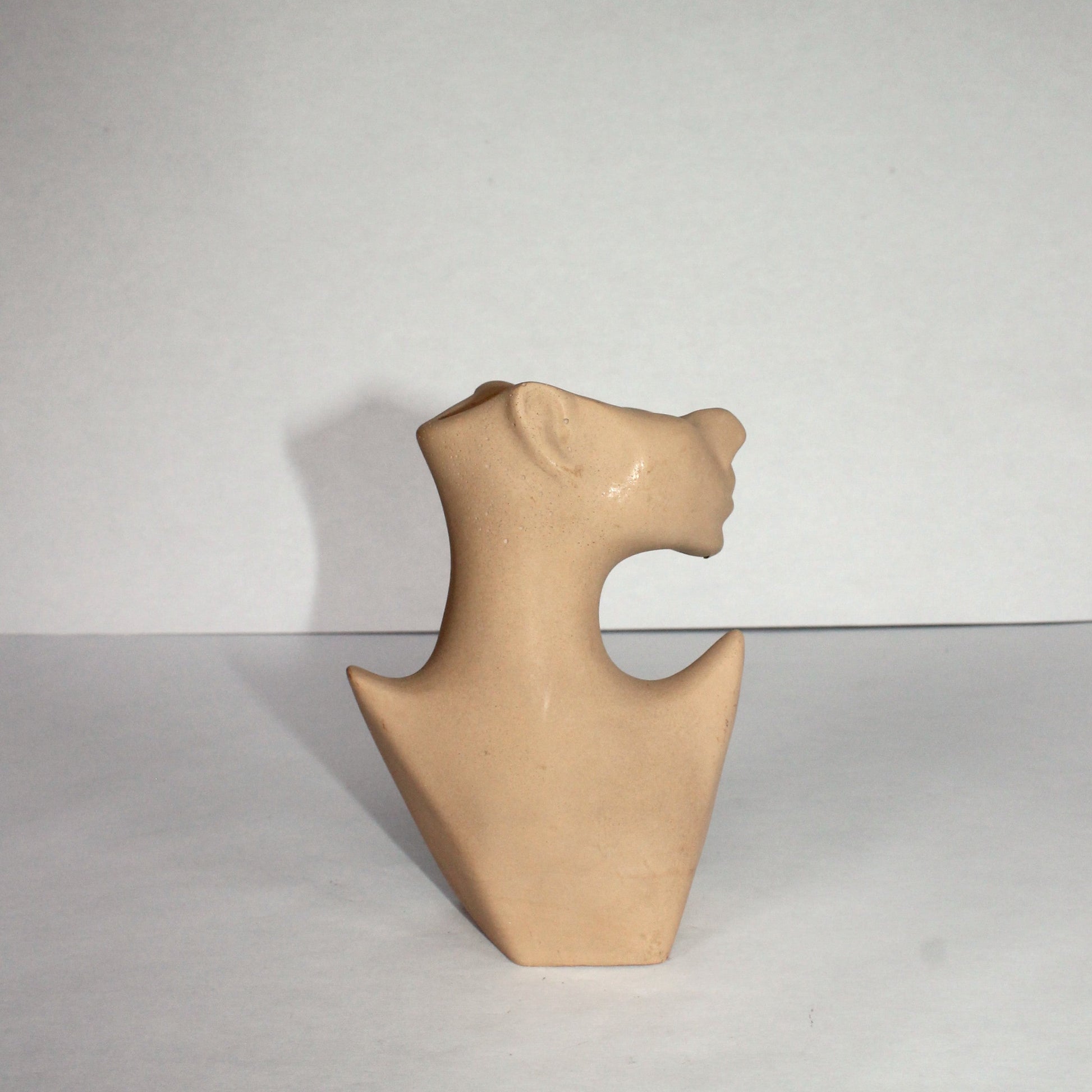 Beige abstract sculpture on a white background