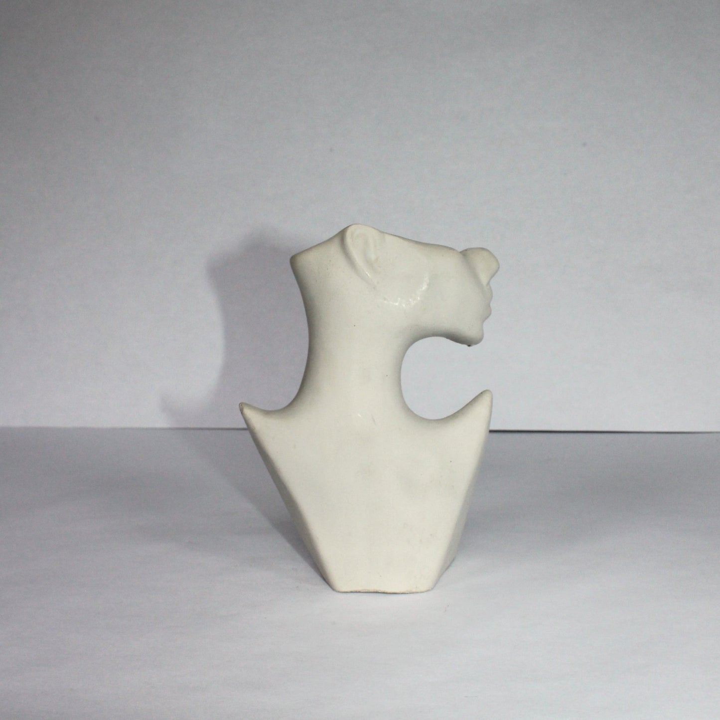 White abstract concrete sculpture on a gray background