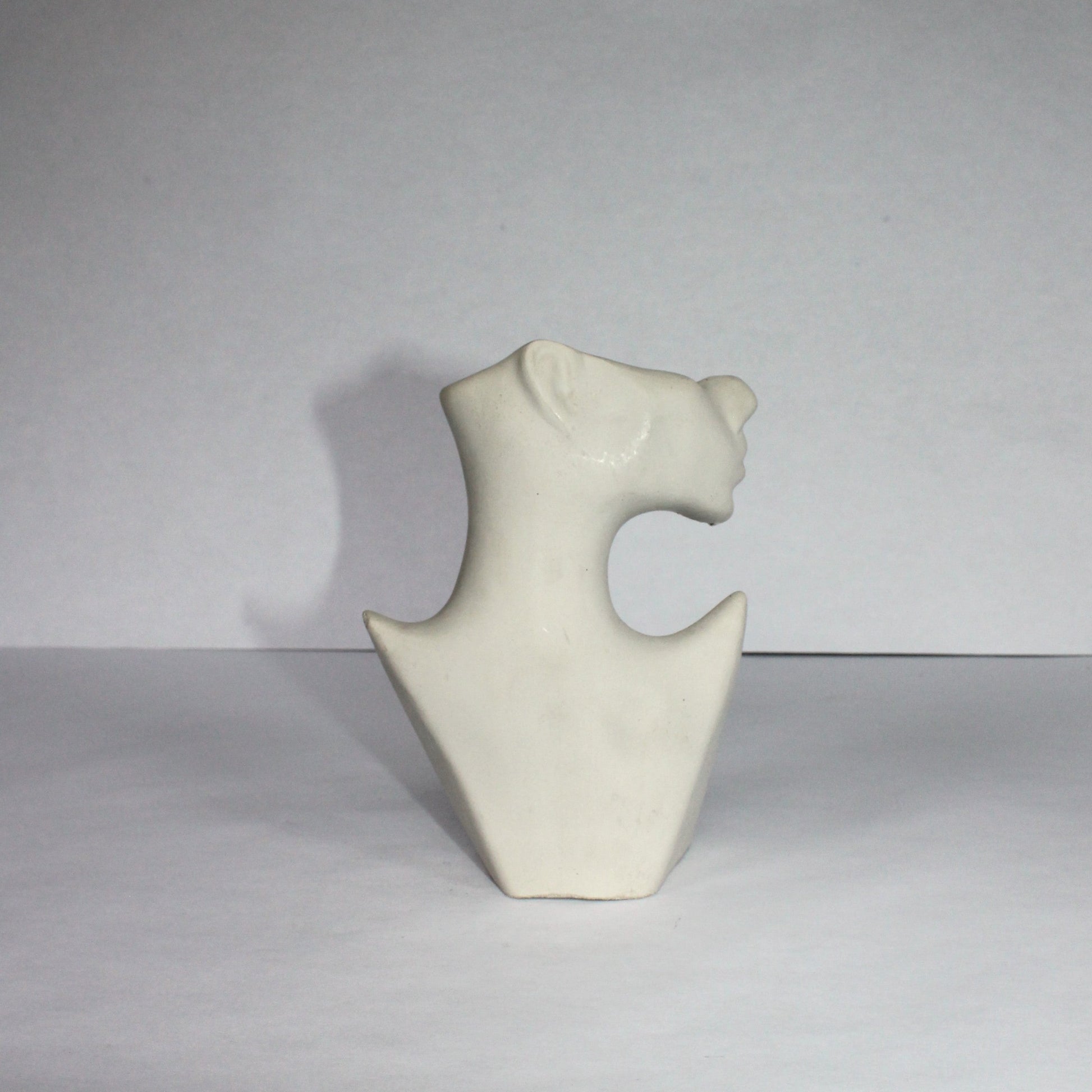 White abstract concrete sculpture on a gray background