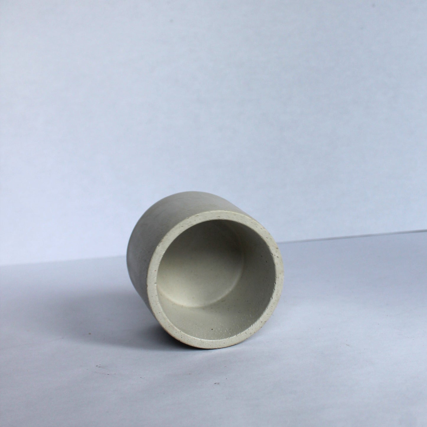 inside of concrete pot on a white background