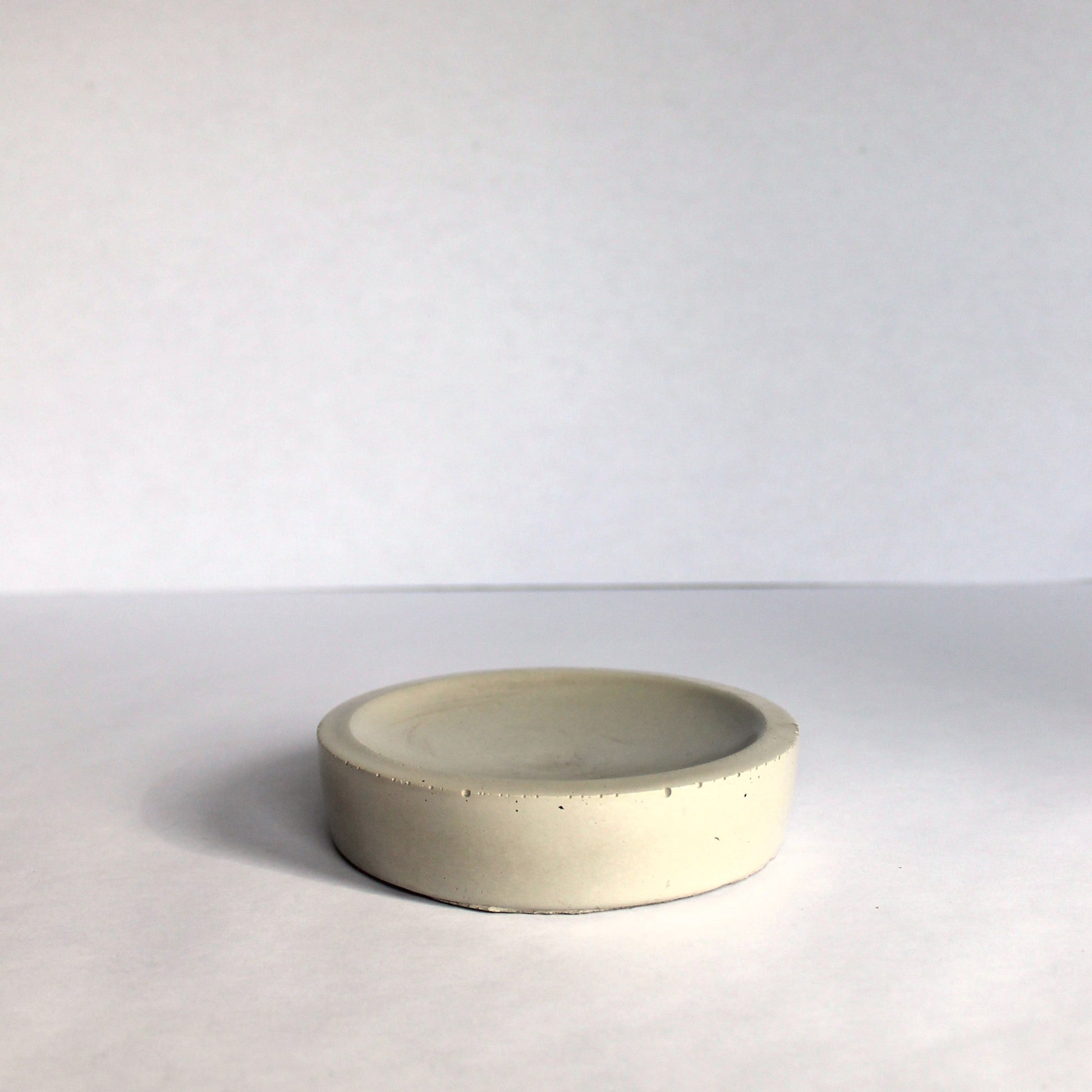 Light gray concrete bowl on a white background