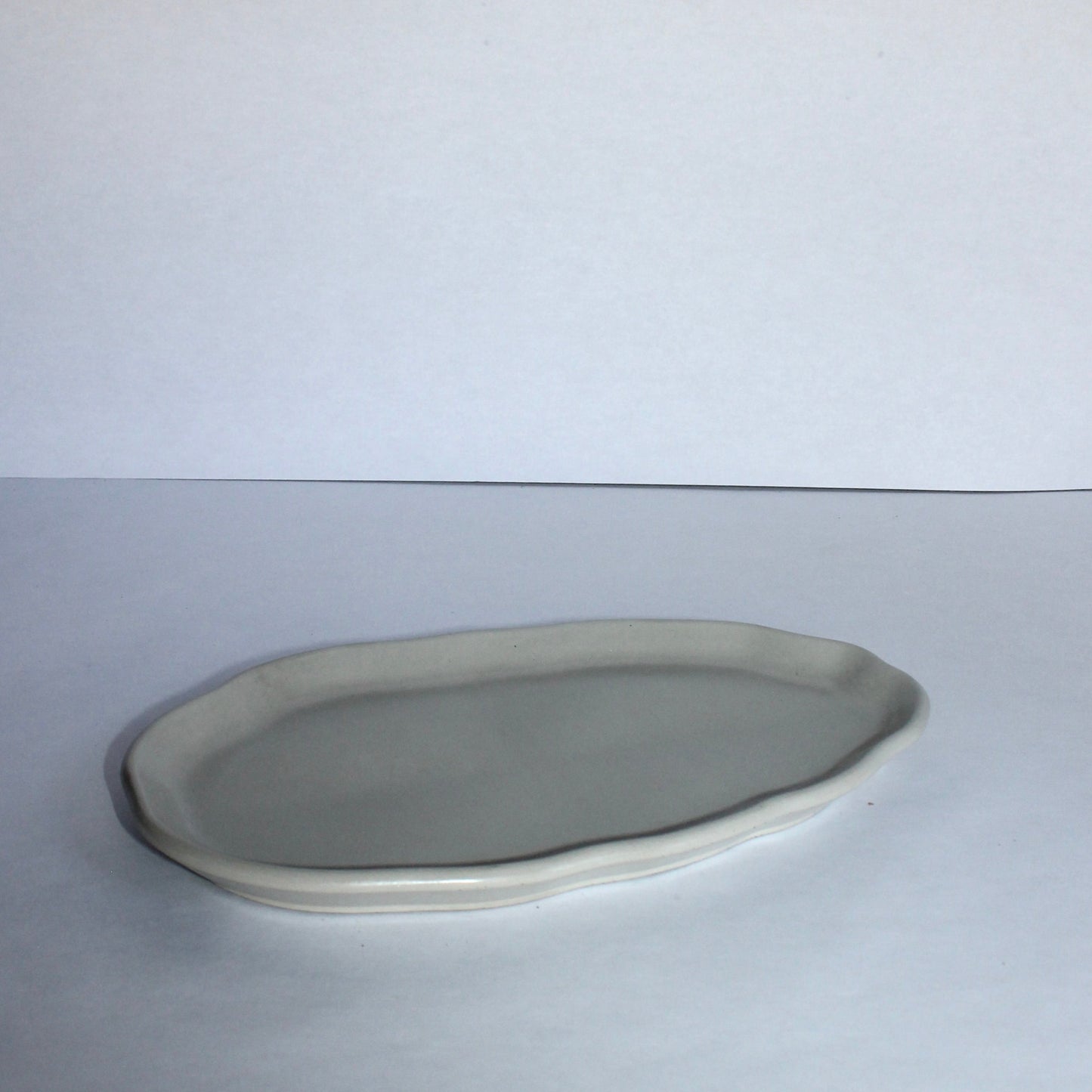 Oval ceramic plate on a white background