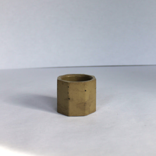 Green hexagonal concrete vessel on a white background