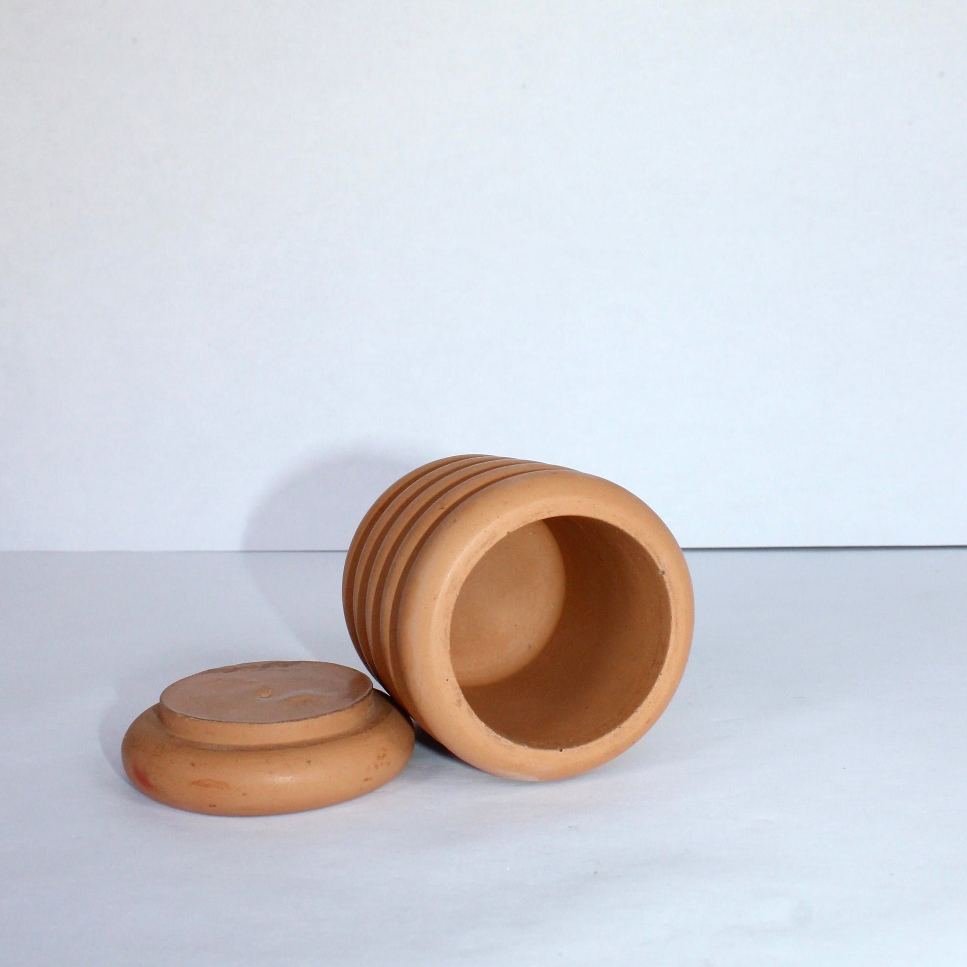 clay bubble jar with lid on a white background