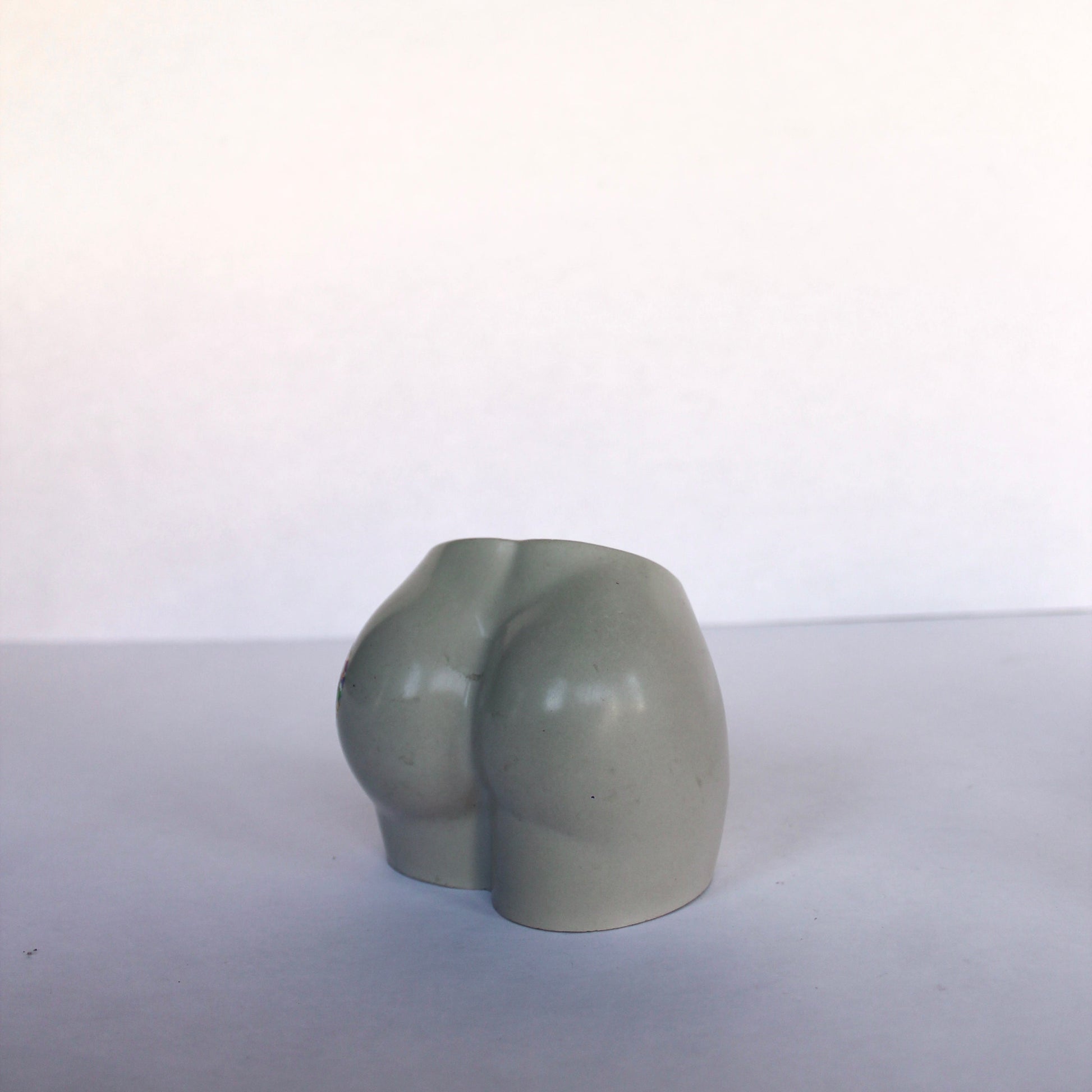 Gray concrete bum vase on a white background