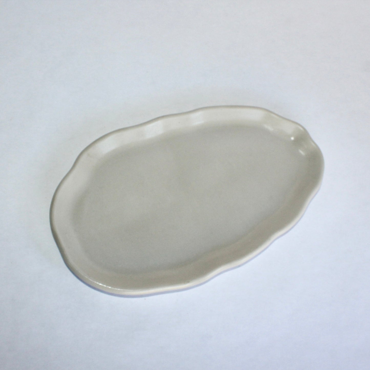 light gray decorative concrete plate on a white background