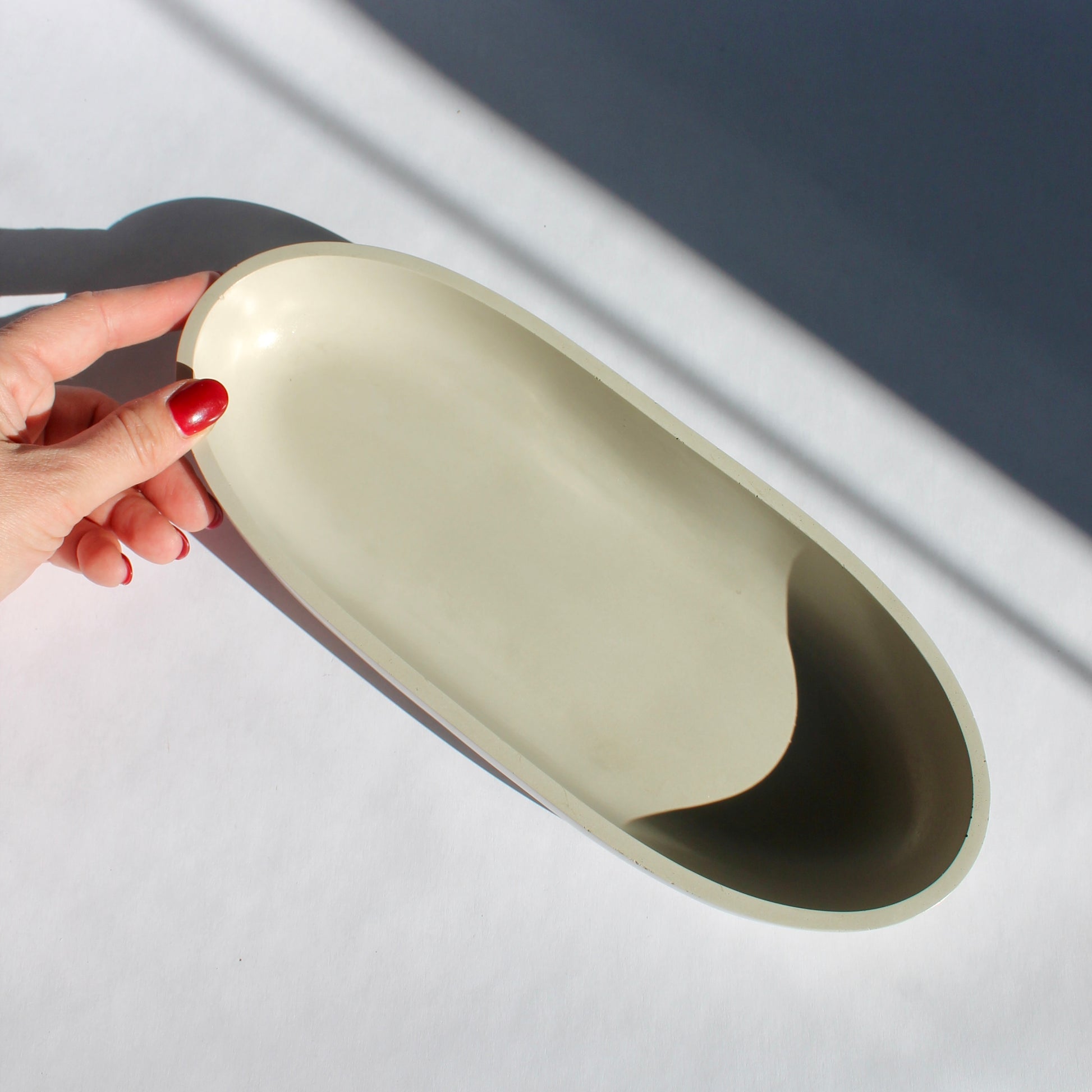 long gray concrete oval bowl