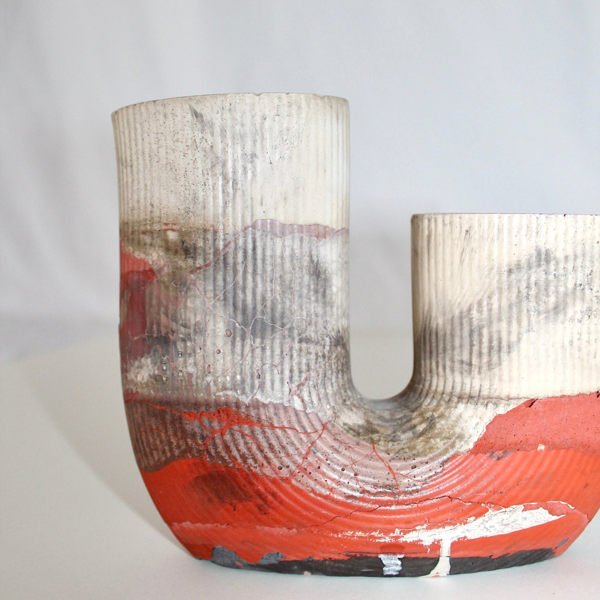 Decorative high end vase with textured surface and orange base on a white background