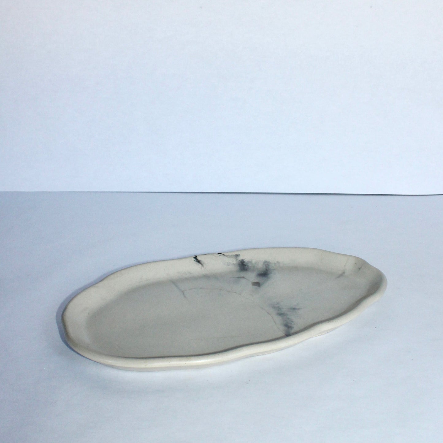 Marble-patterned cement plate on a white background