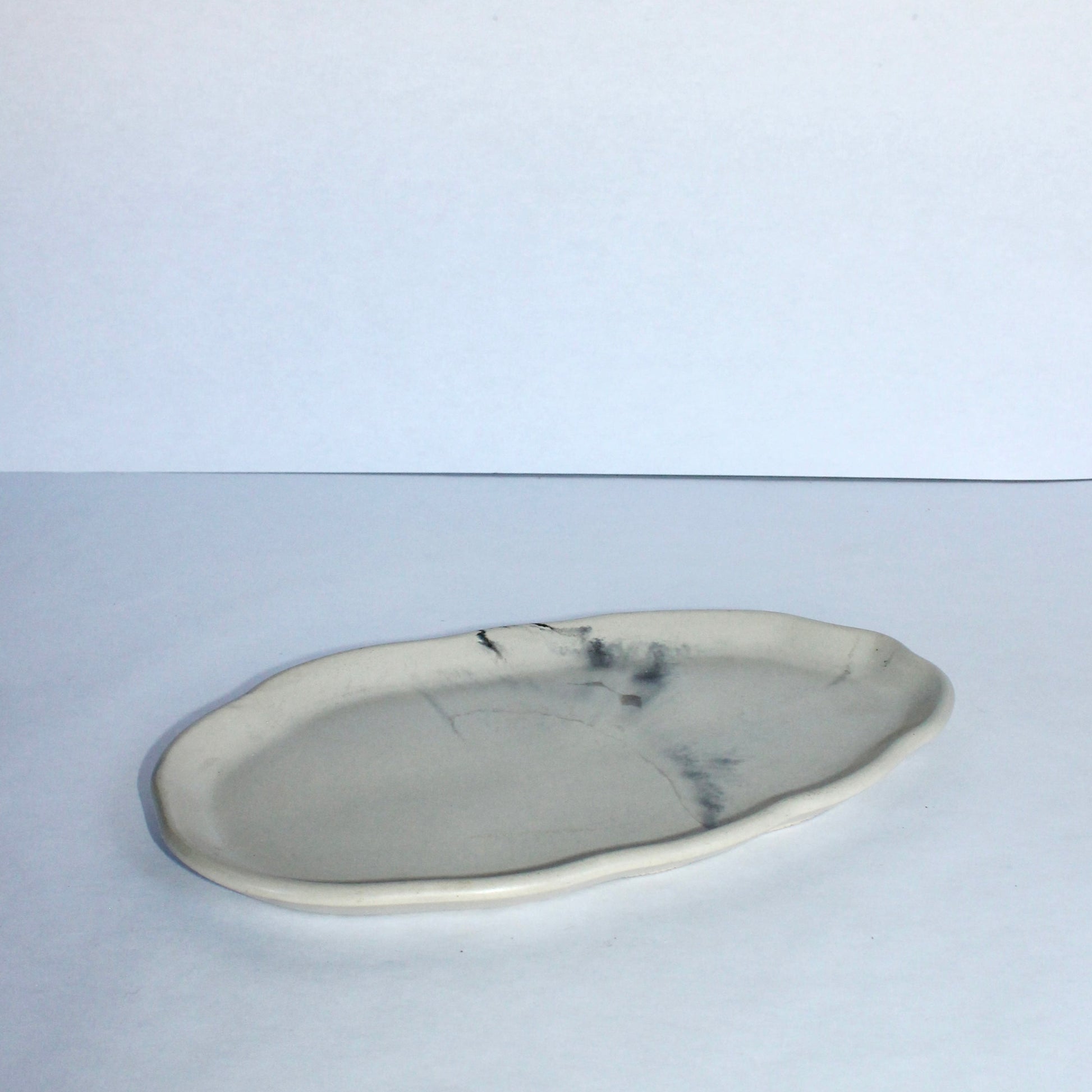 Marble-patterned cement plate on a white background