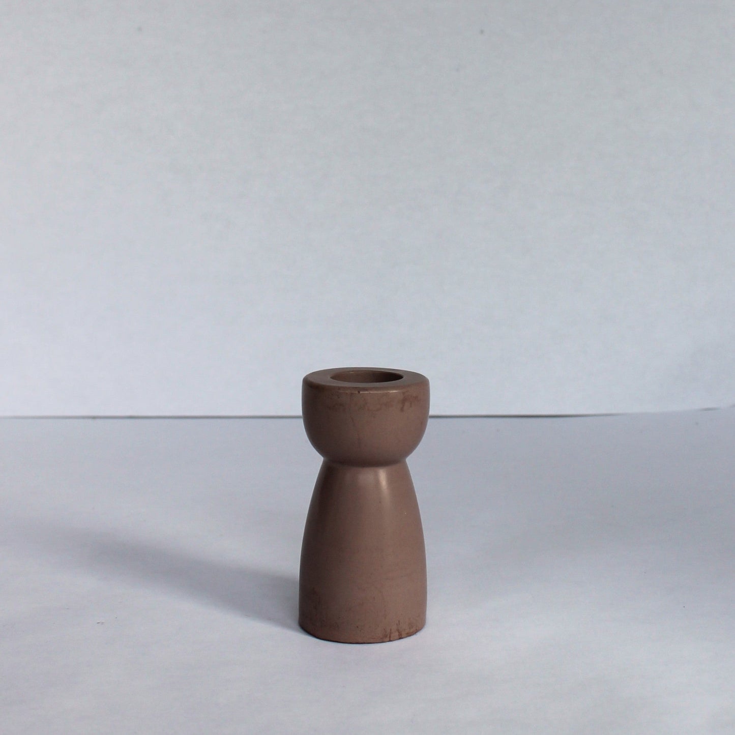 Brown concrete candle stick holder on a white background