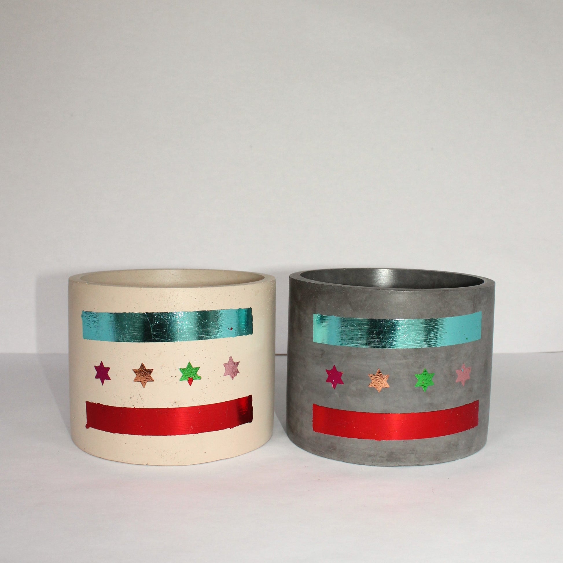 Two decorative concrete pots with Chicago flag star and stripe patterns on a white background