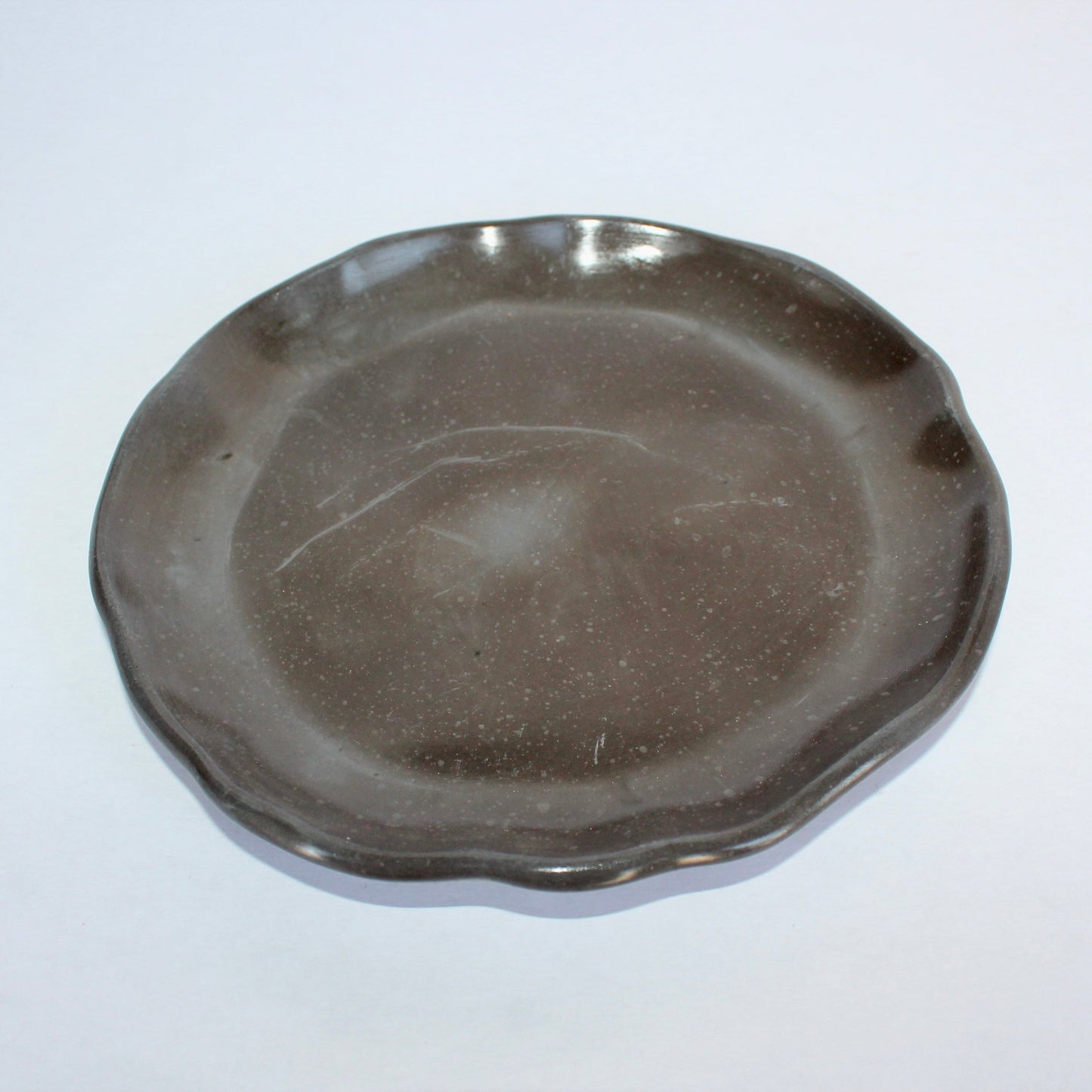 Round black tray on a white background