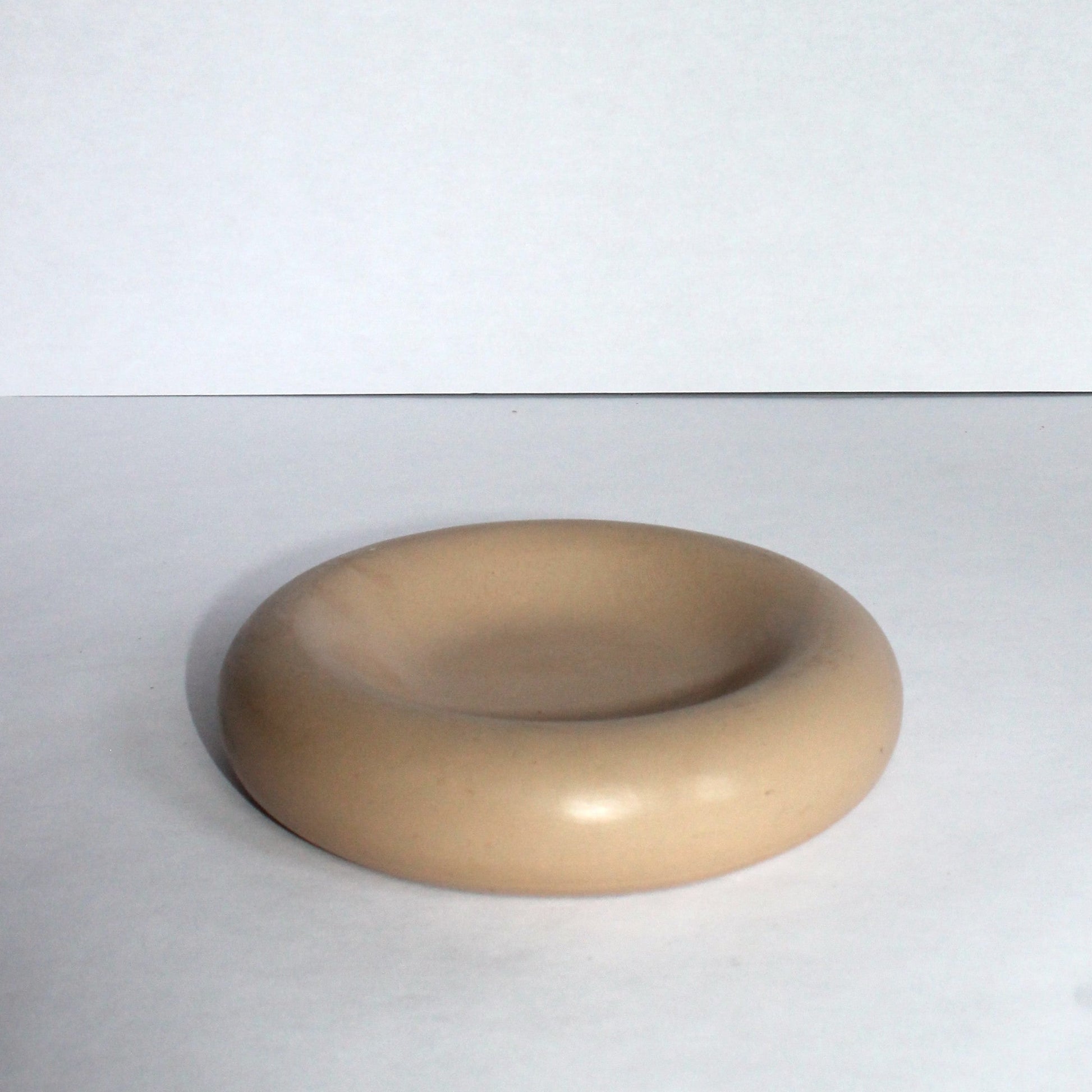 Beige concrete round tray on a white background