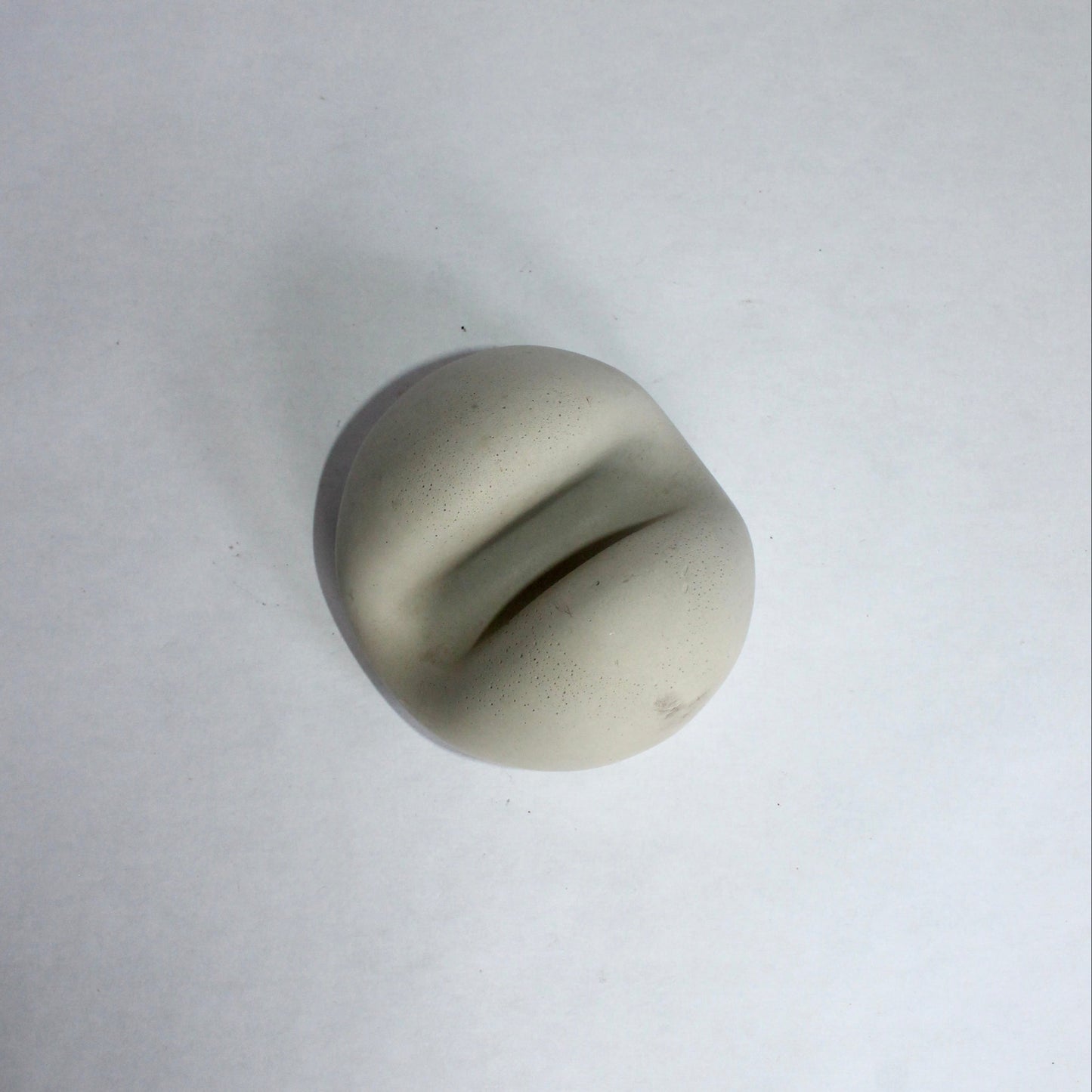 Round gray phone stand on a white background