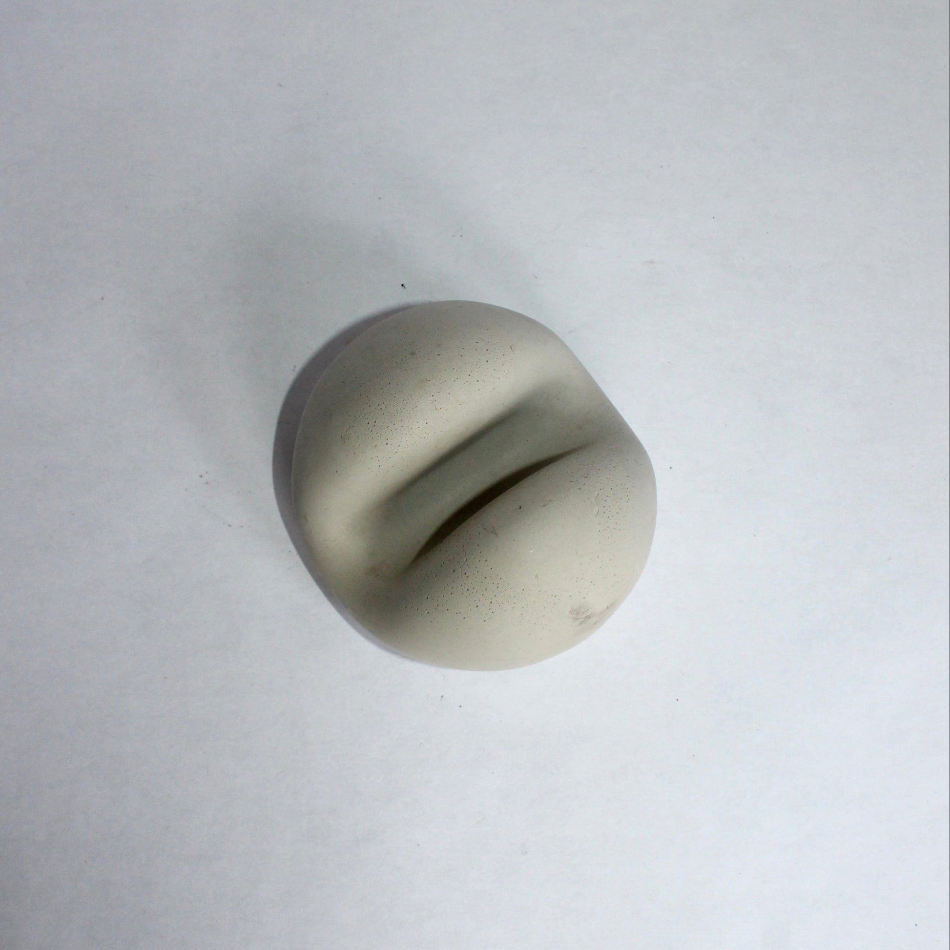 Round gray phone stand on a white background