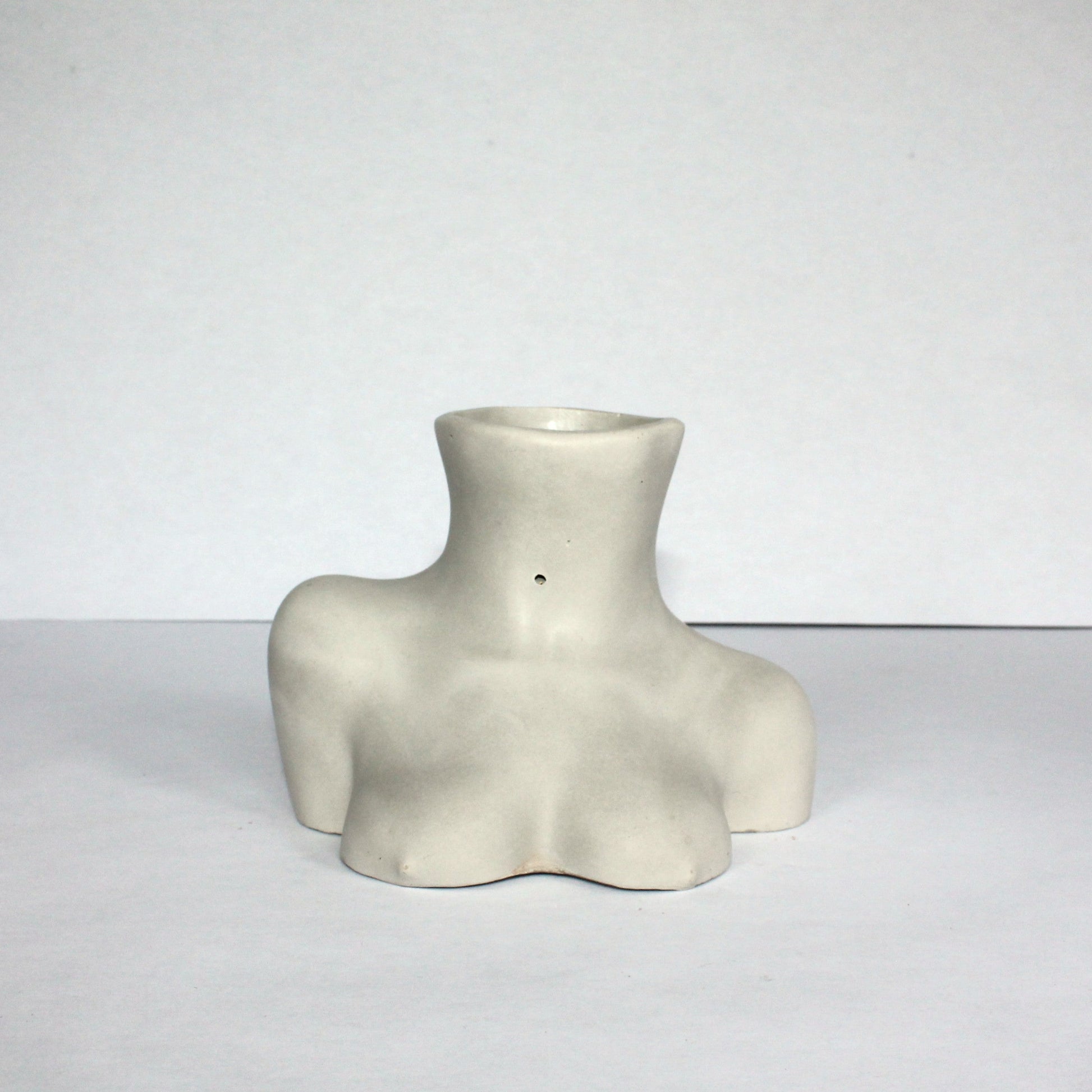 Light gray concrete female figure vase on a white background