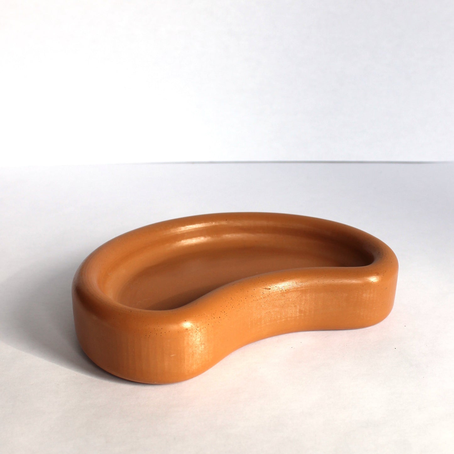 Side view of thick concrete tray on a white background