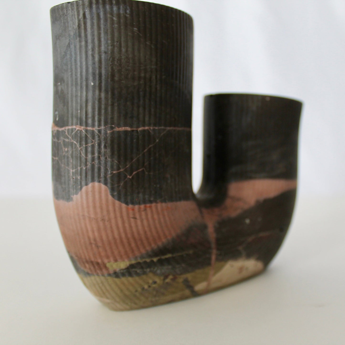 Cement vase with organic pattern on a white background